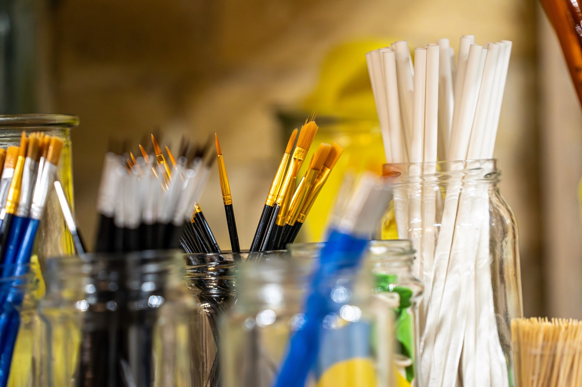 brushes of various size and masking tape for painting pottery
