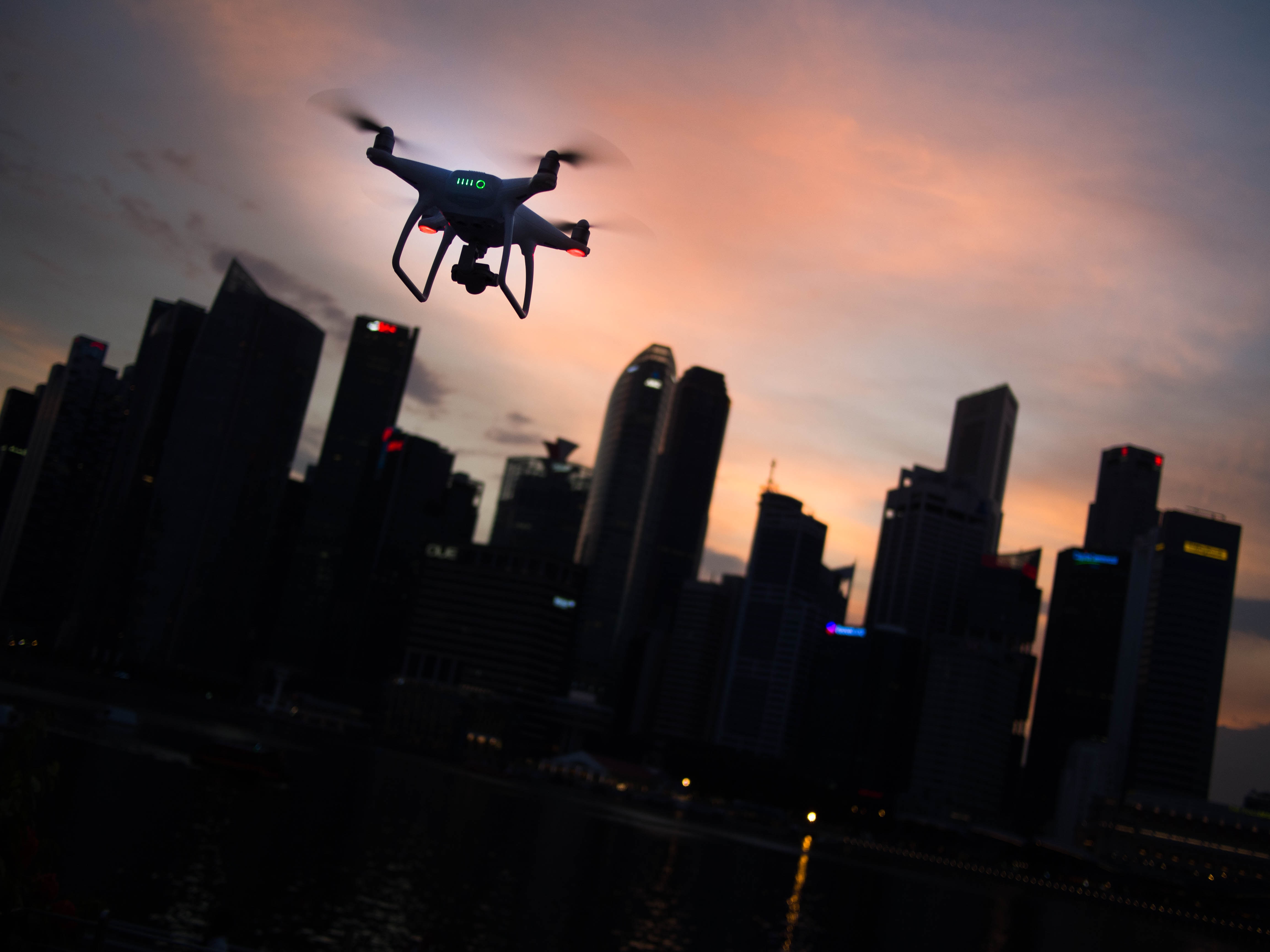 drone flying in city at night