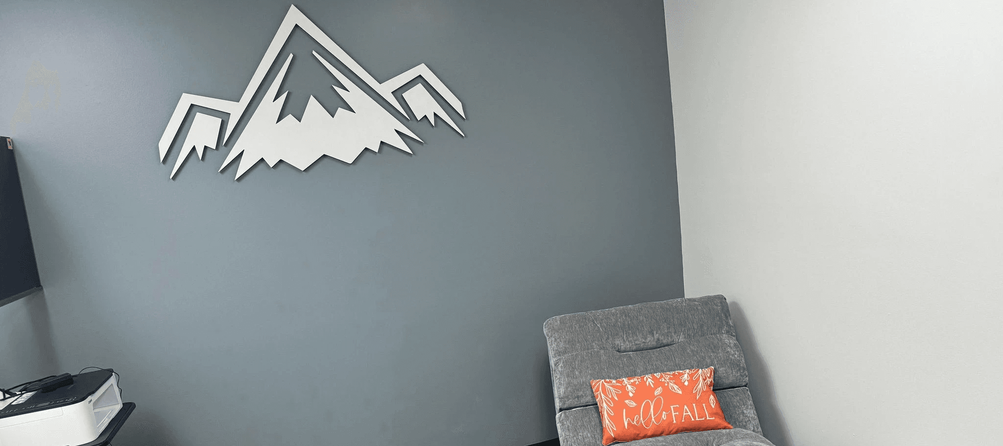 RMR chair with elevate performance labs logo on the wall