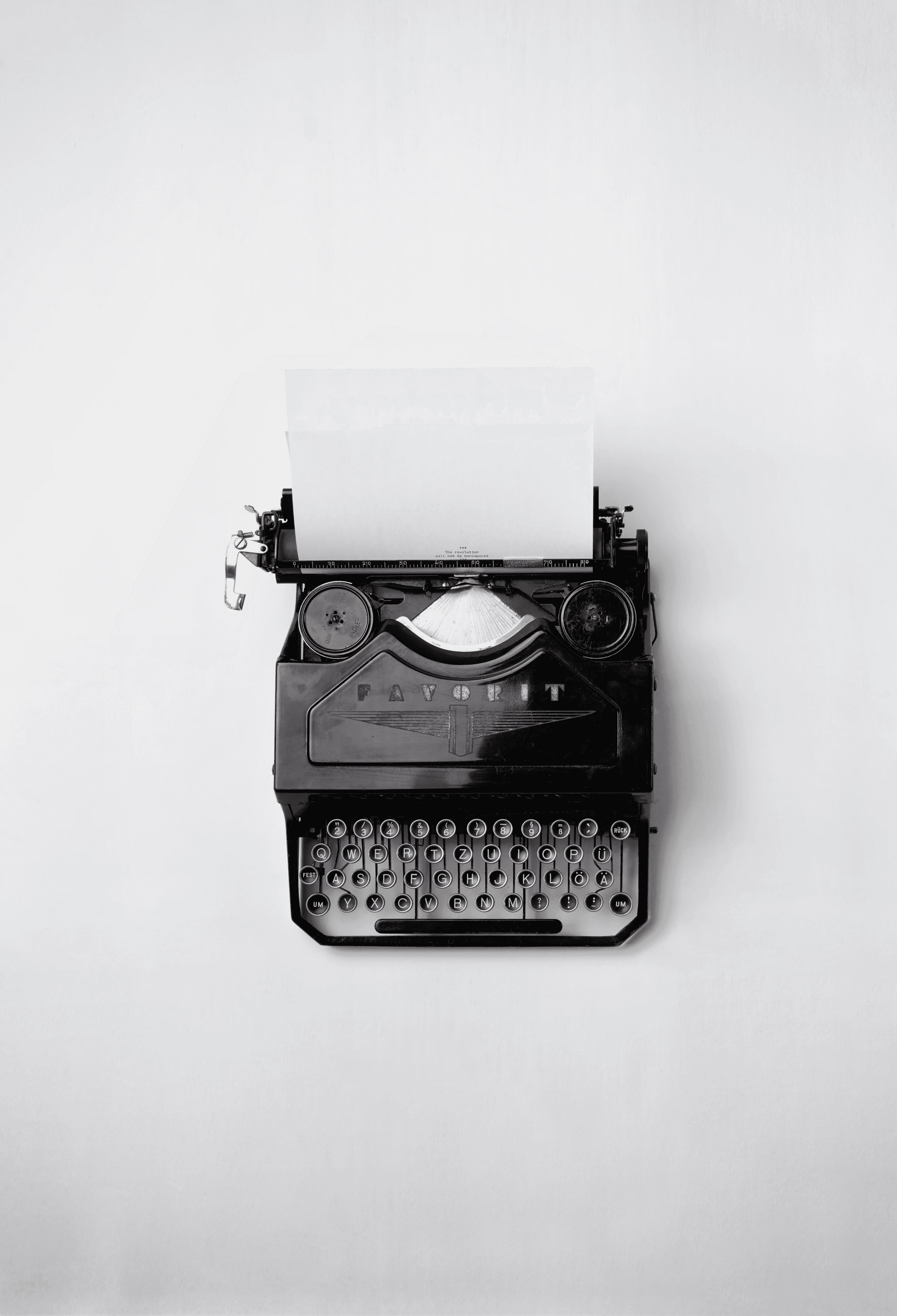 black Fayorit typewriter with printer paper | Let Me Learn