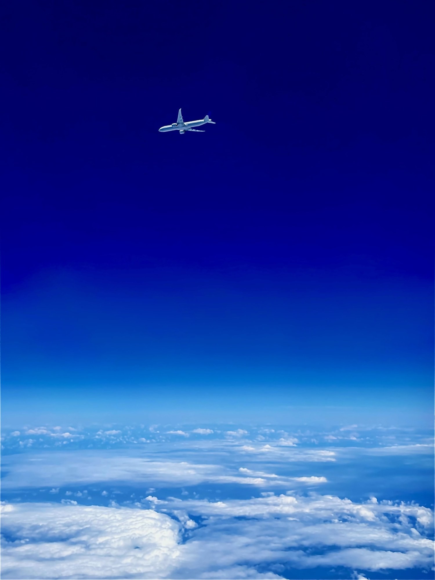 Rob McCall's Boeing 777 at cruise above the clouds, photographed from a passing aircraft