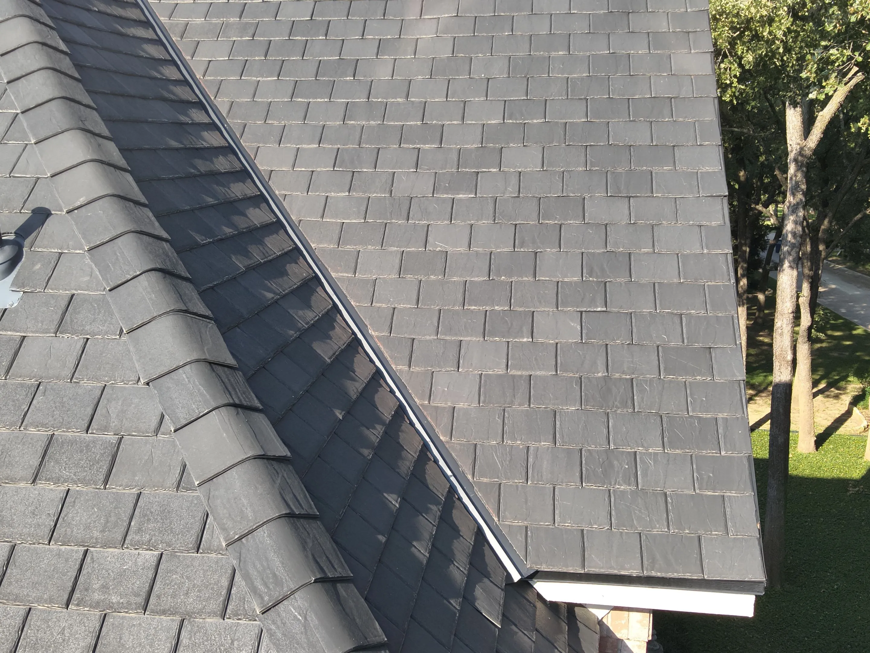 F-Wave synthetic roof ridge detail showing proper installation techniques and high-quality materials on Corinth Texas home