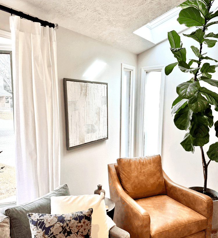 calm body of water near brown mountain under white and gray sky