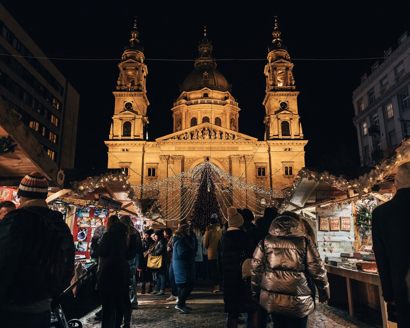 a christmas market with lots of decorations and lights