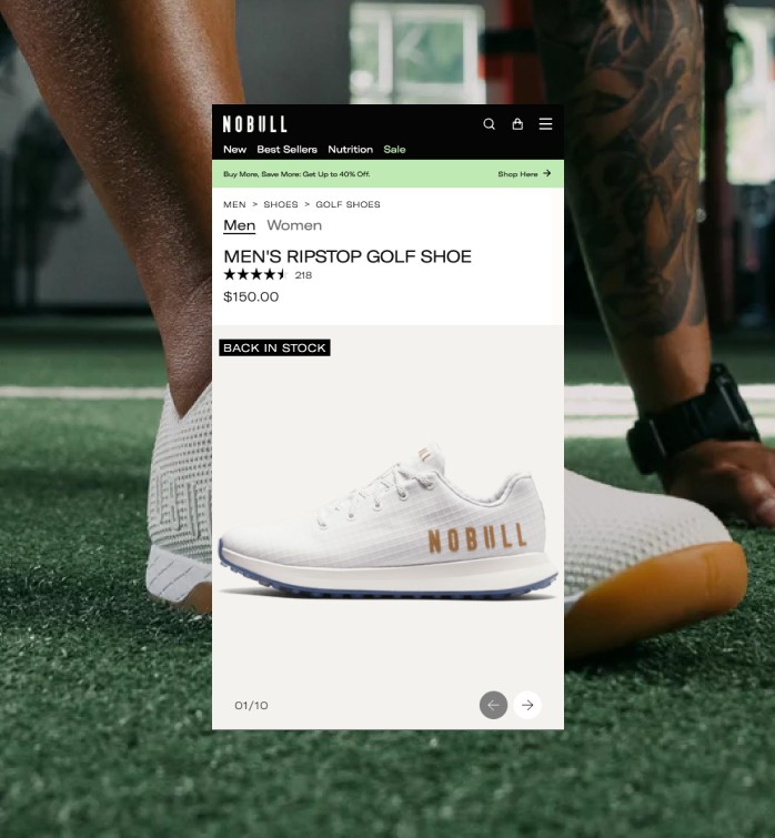 Trains at a station with sun shining through roof.