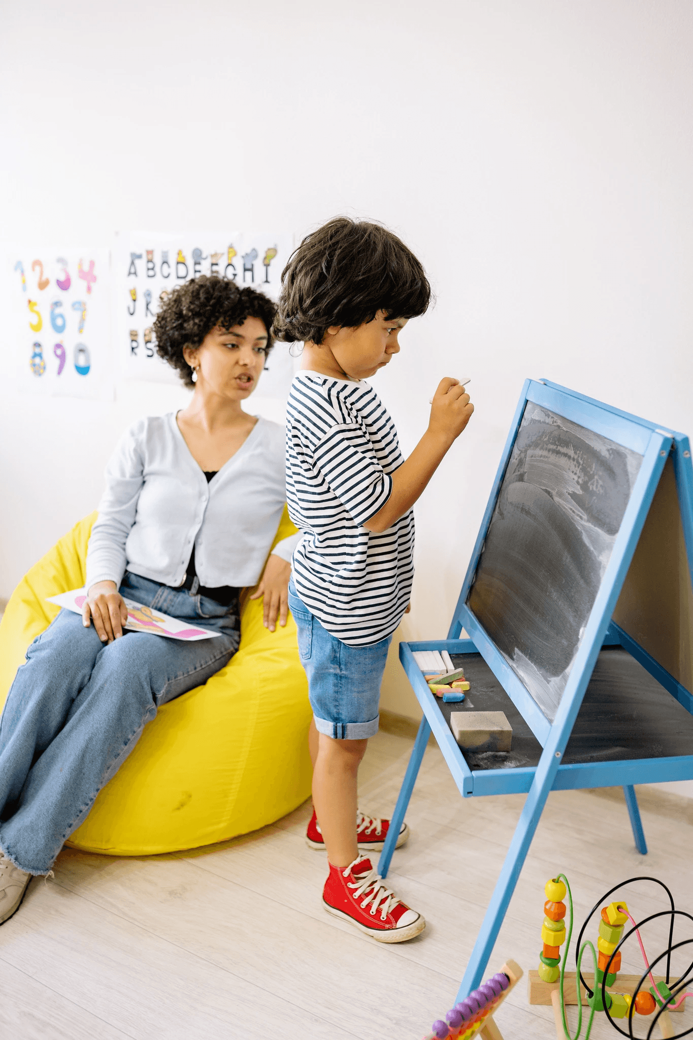 Young girl practicing speech sounds with a pediatric speech therapist