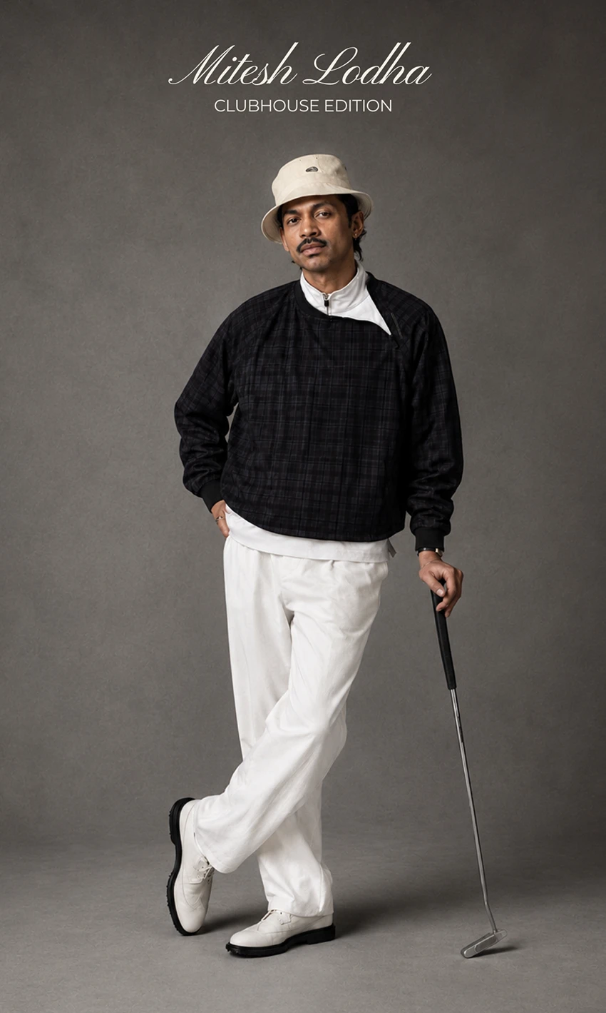 A man in a cream bucket hat, navy check pullover and white trousers leans on a putter on grey, under "Mitesh Lodha Clubhouse Edition".