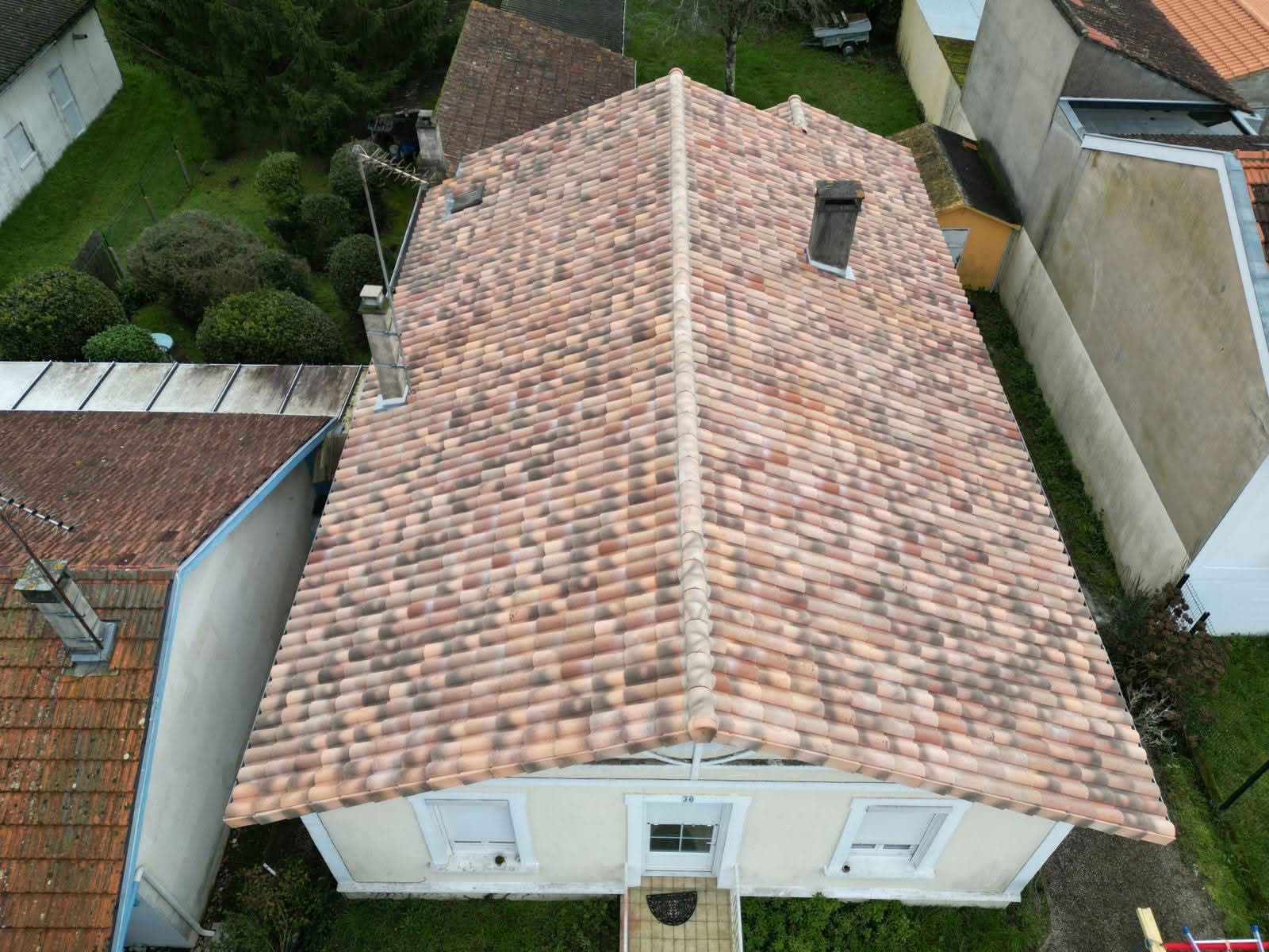 a man working on a roof with a power drill