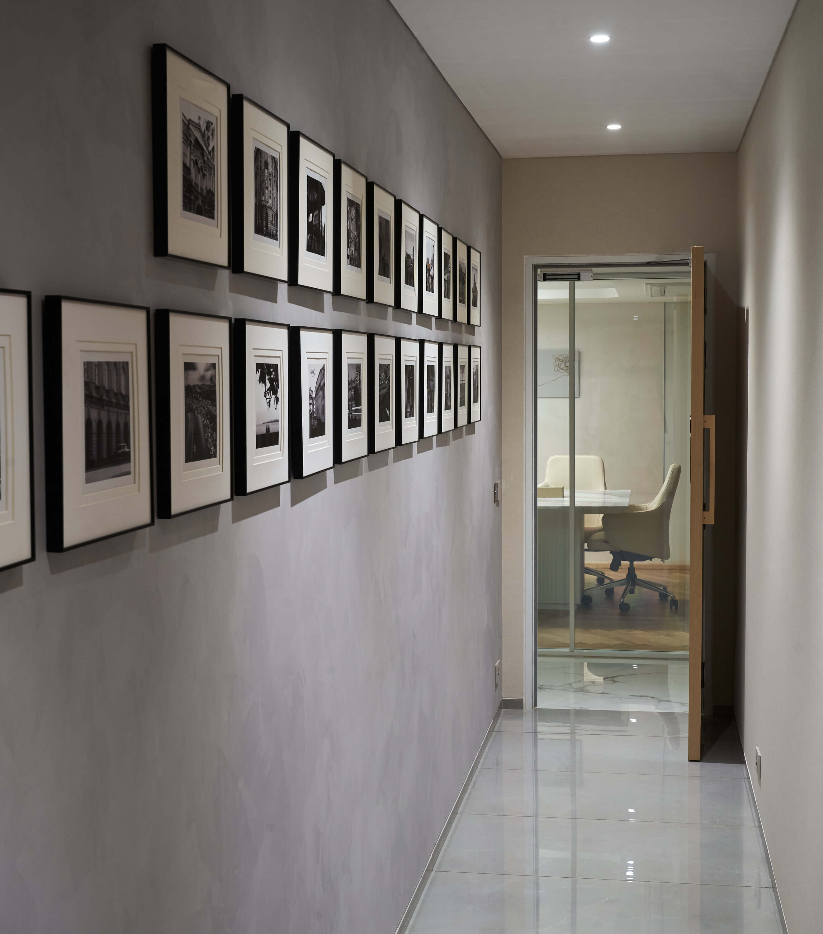 Minimal hallway with framed black-and-white photography gallery wall.