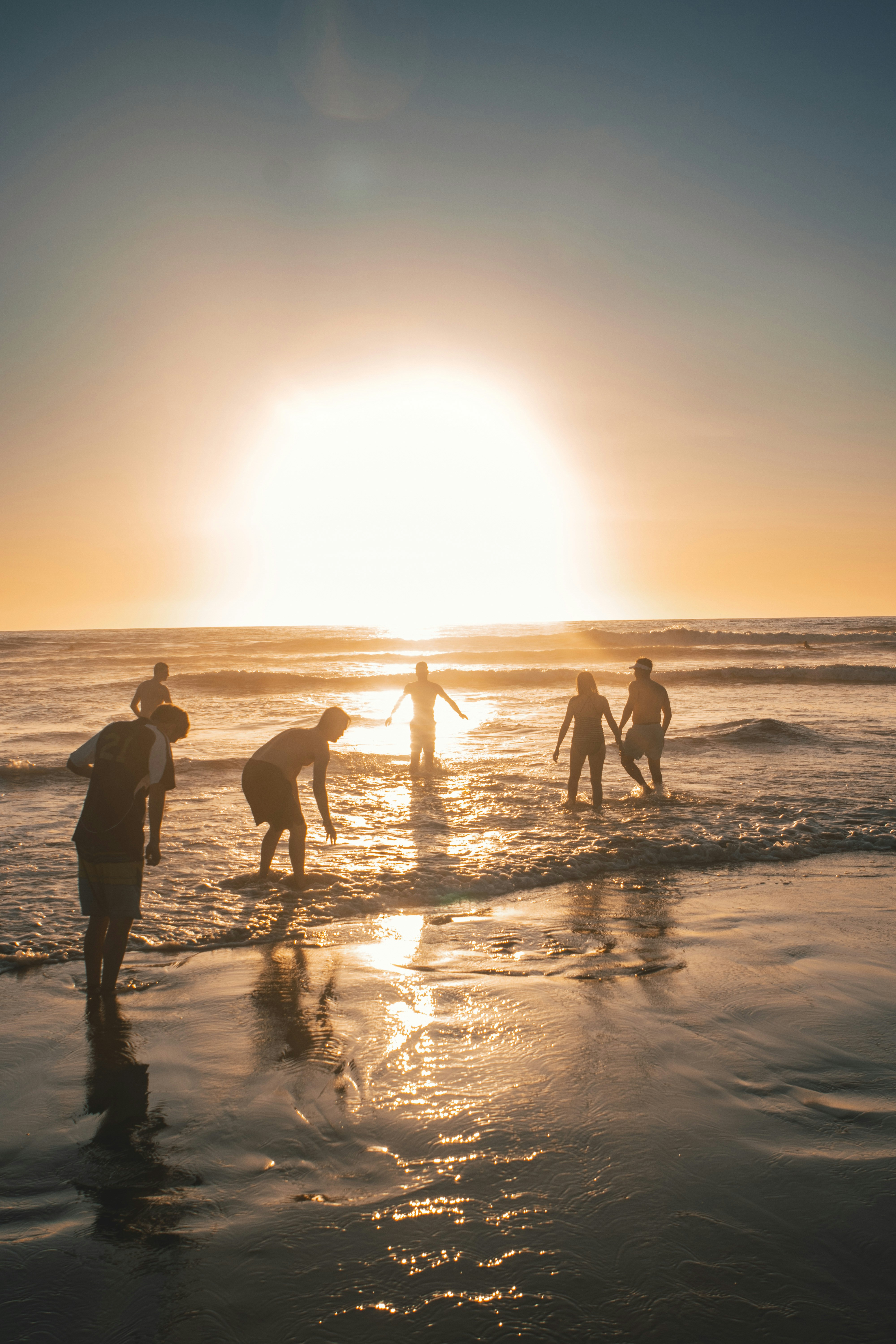 silhouette of people on beach during sunset
