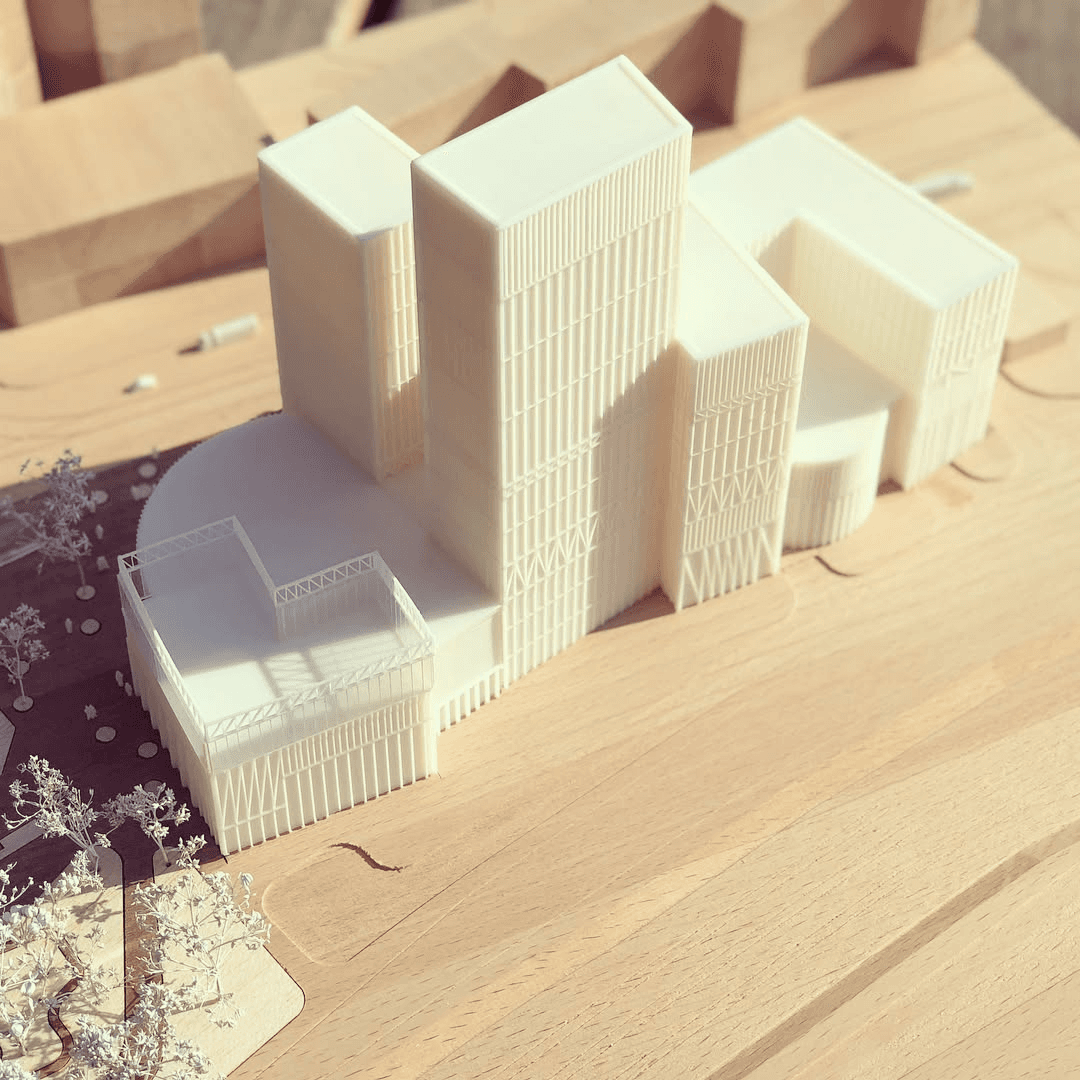 Wooden base with white 3d printed building shoot taken from a left side
