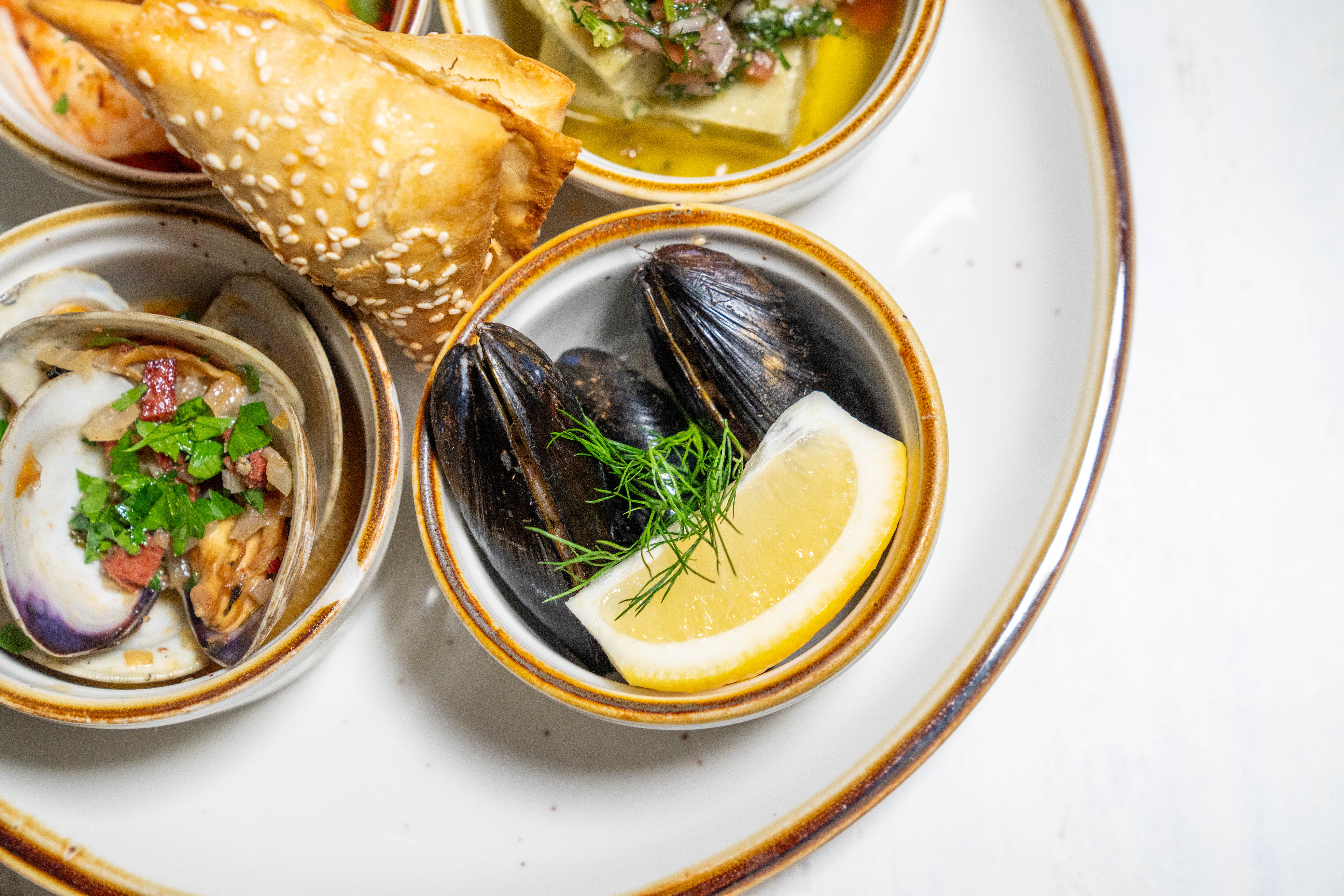 space gray iPhone X beside turned on laptop beside coffee and succulent plant