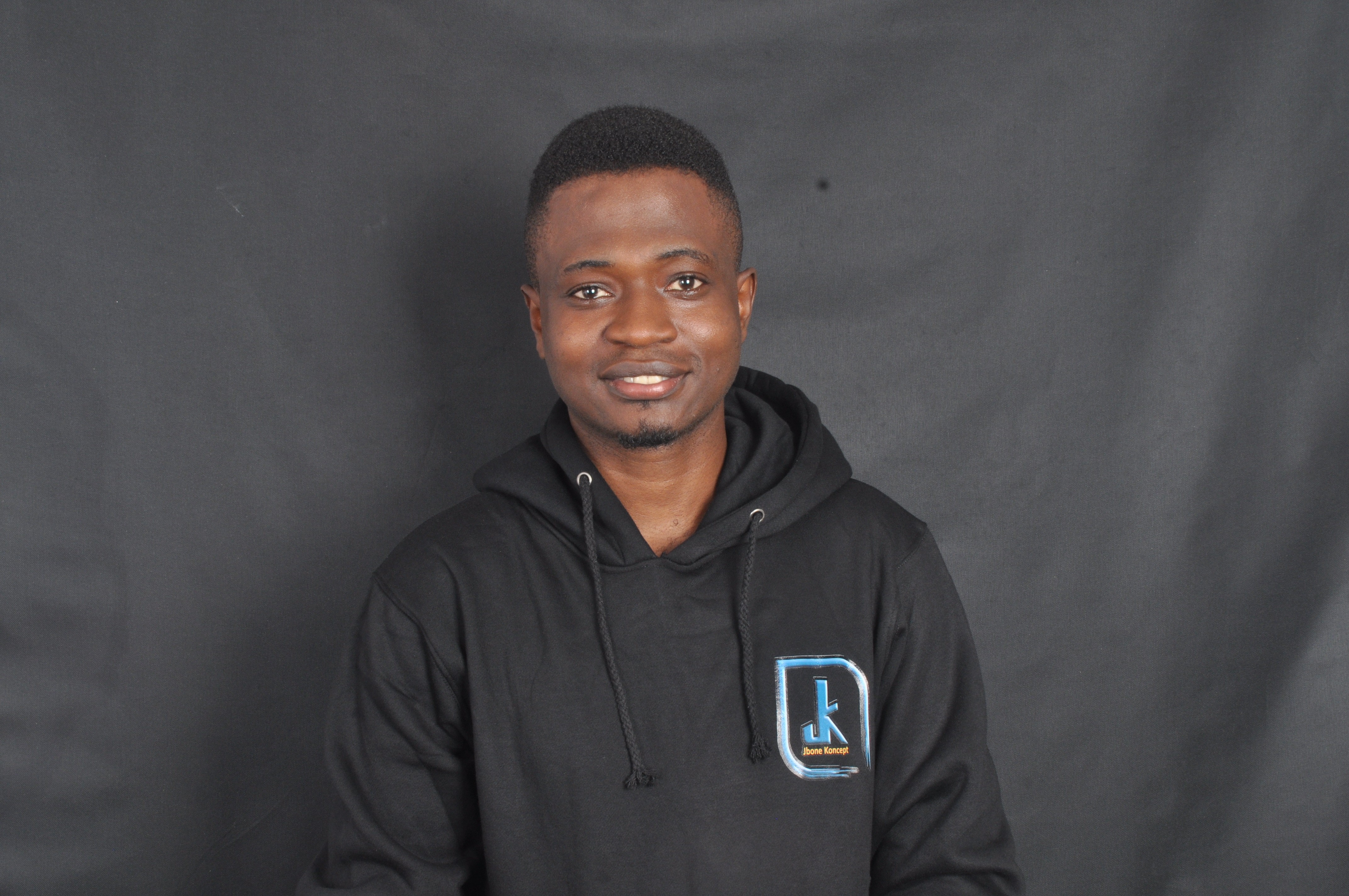 Young white male sitting on a desk