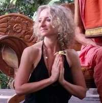 woman sitting near pink flowers at daytime