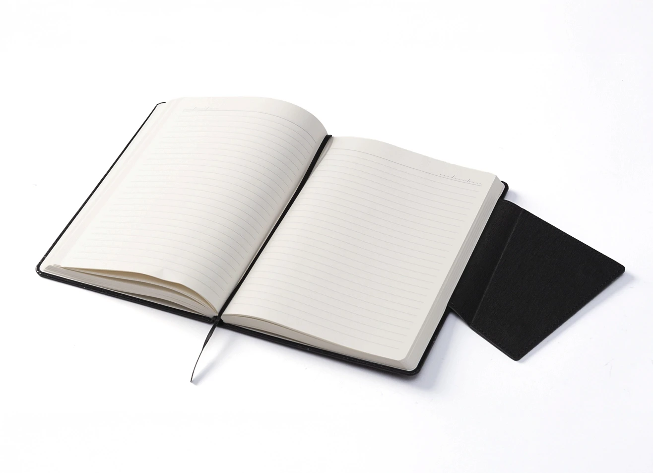 Open notebook displaying lined pages and black ribbon bookmark.