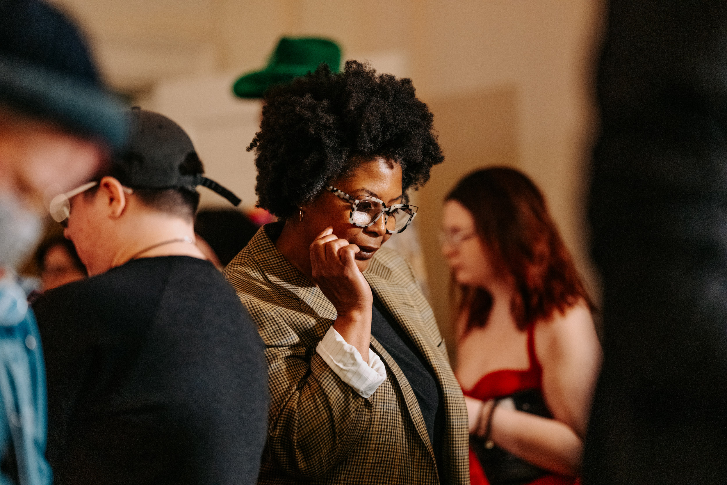 Attendee reflecting during Queer Open Mic hosted by be; community in Bridgewater, Massachusetts