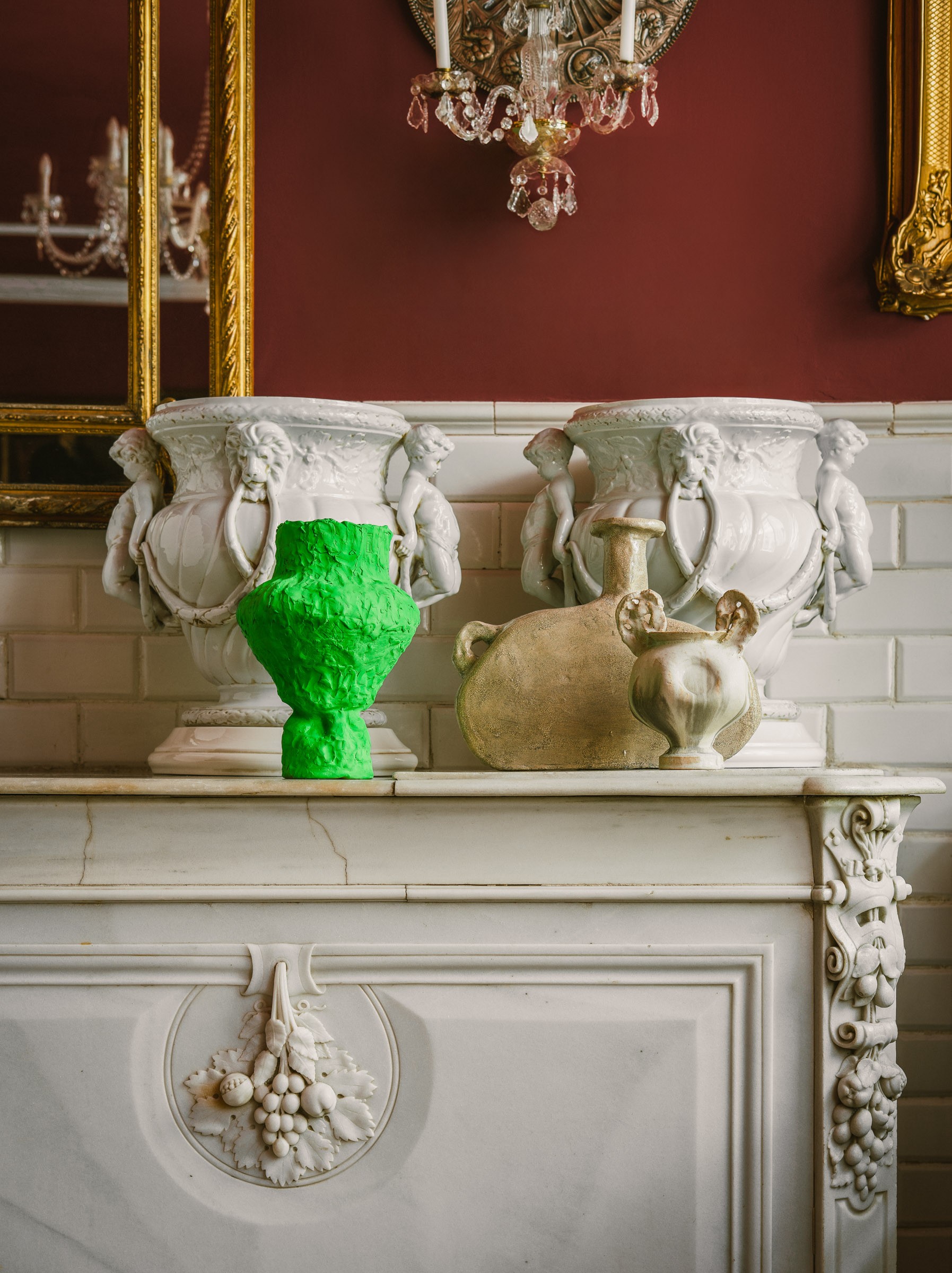Contemporary ceramic pieces displayed on a marble pedestal for Nuevo Estilo