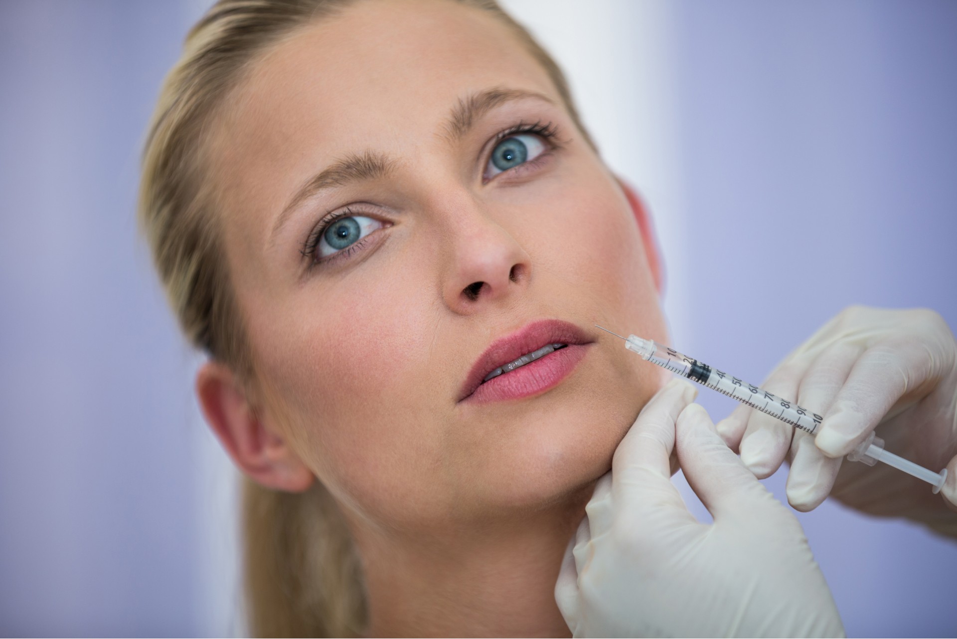 Close-up of a patient receiving a dental checkup with professional tools.