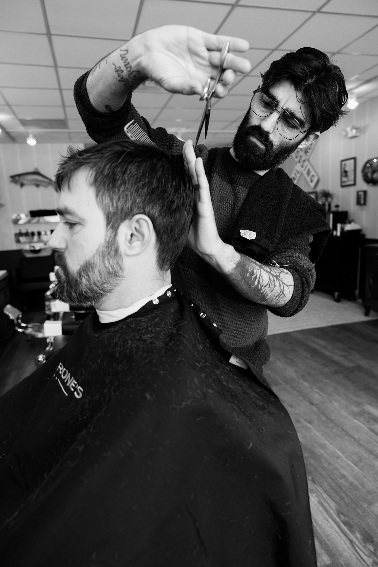 Barber shaping a classic men’s haircut during a full service appointment at Calderone’s Barbershop