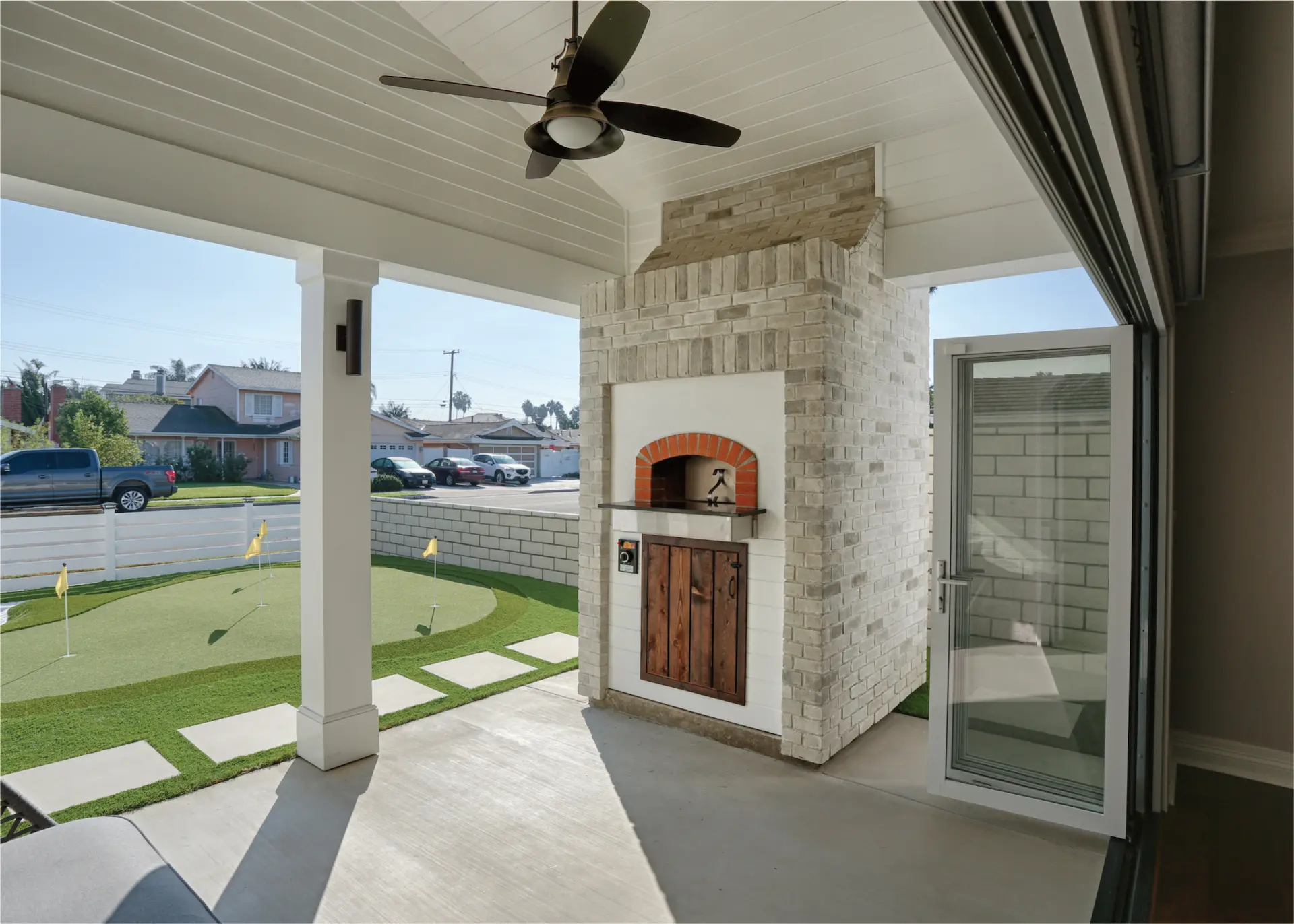 Front covered patio with brick pizza oven, overlooking putting green. Photo by Chris Darnall. Photo by Chris Darnall.