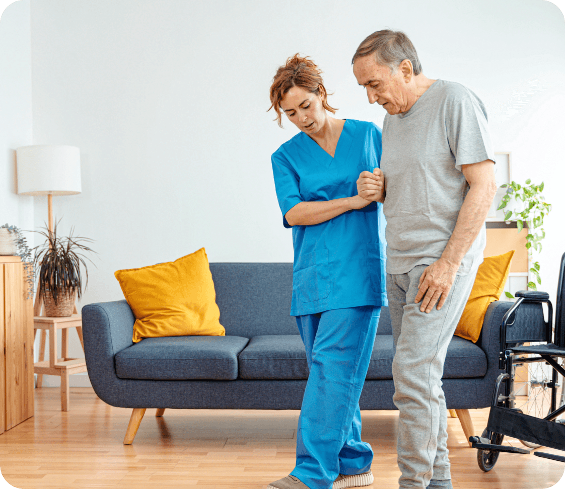 Home-care nurse helping an older adult walk safely with a mobility aid.