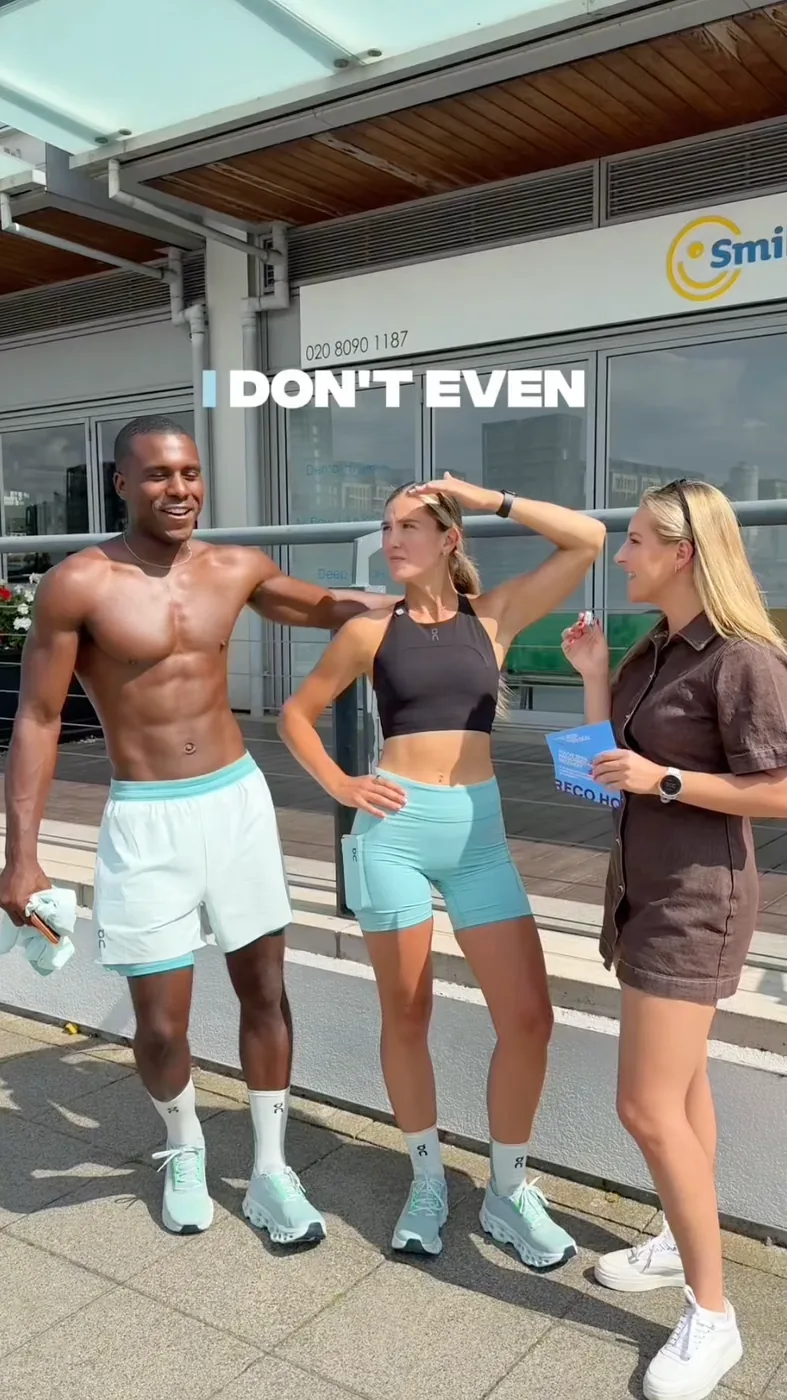 Three people in activewear posing together outside a building