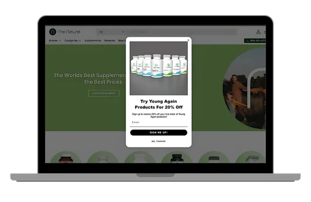 Laptop displaying a 20% discount popup for Young Again supplements on The Natural website.