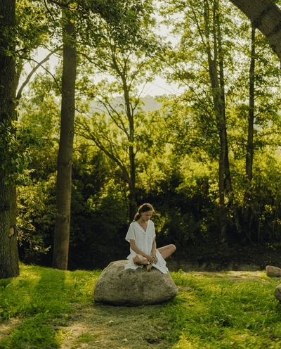 Woman sitting on stone