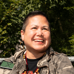 Possible member smiling and looking away from the camera.