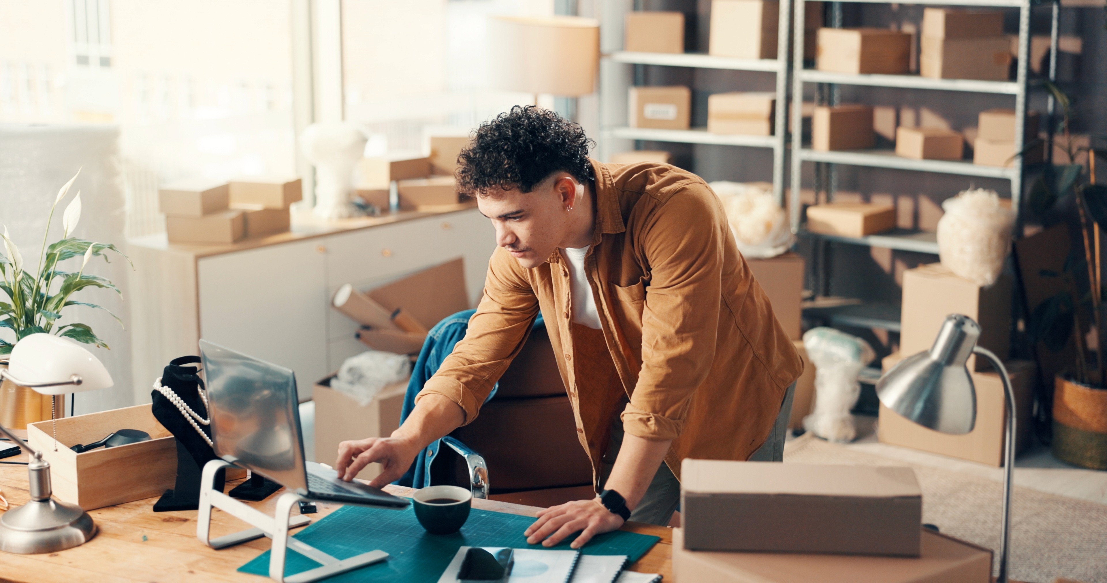 Image of a small business owner working on laptop, relaxed workspace.