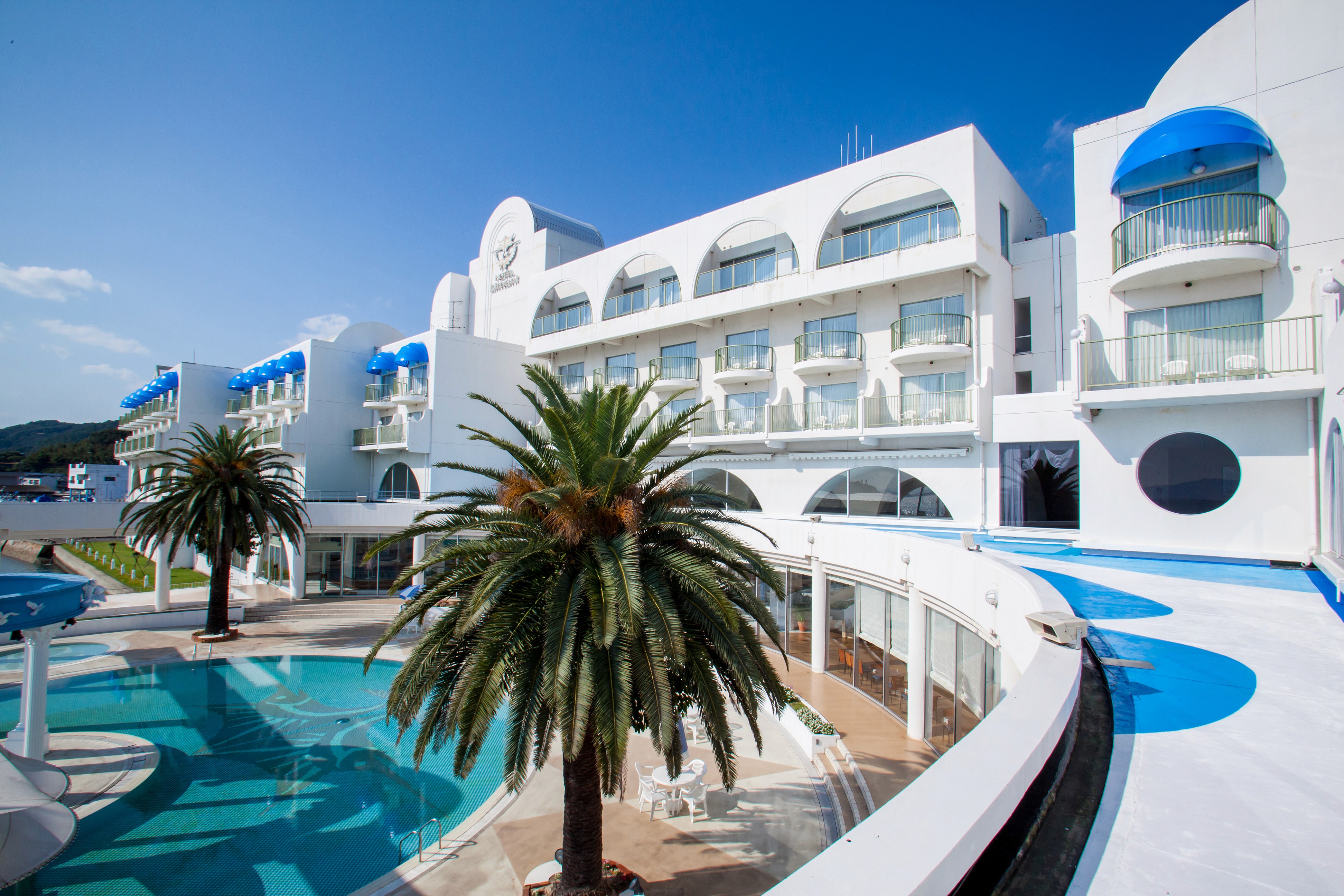 Interior of Hotel Limani's Greek inspired lobby with palm trees