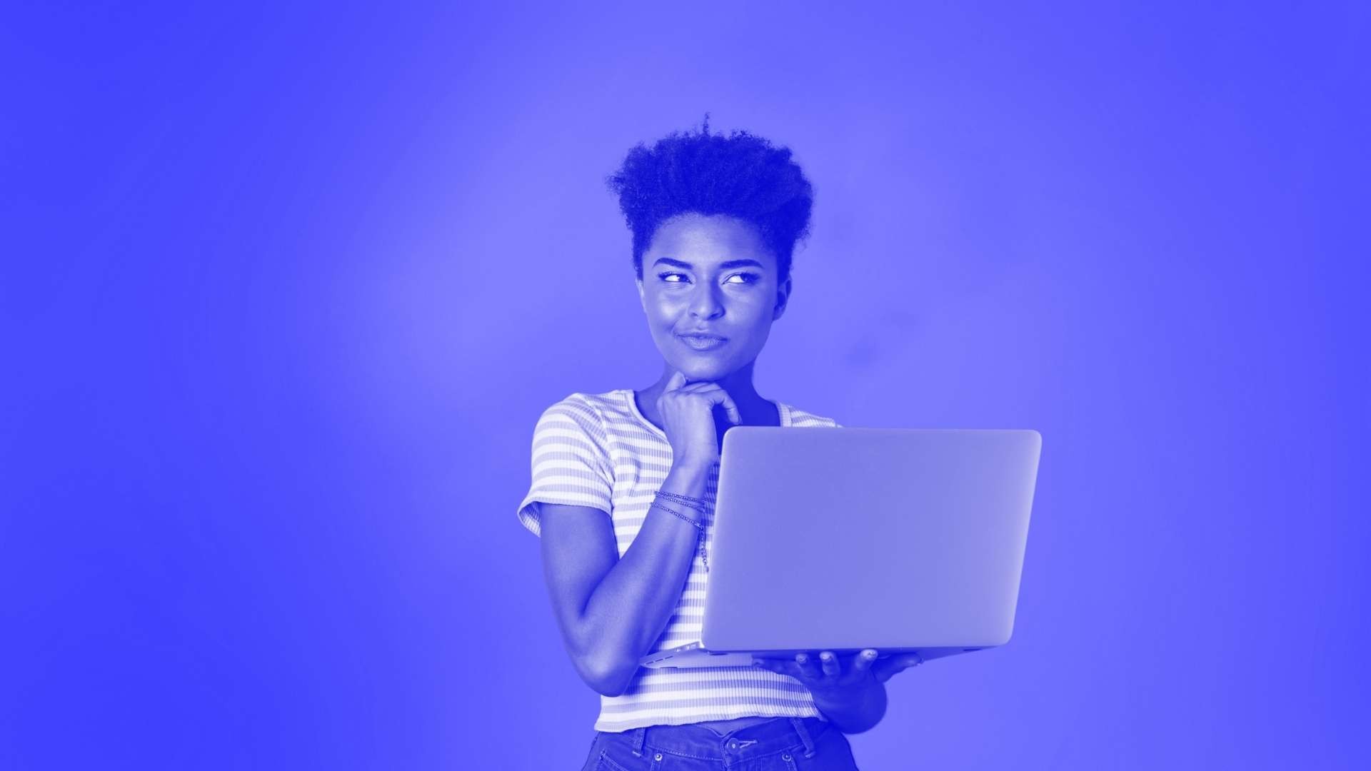 Woman with short hair holding a laptop and thinking