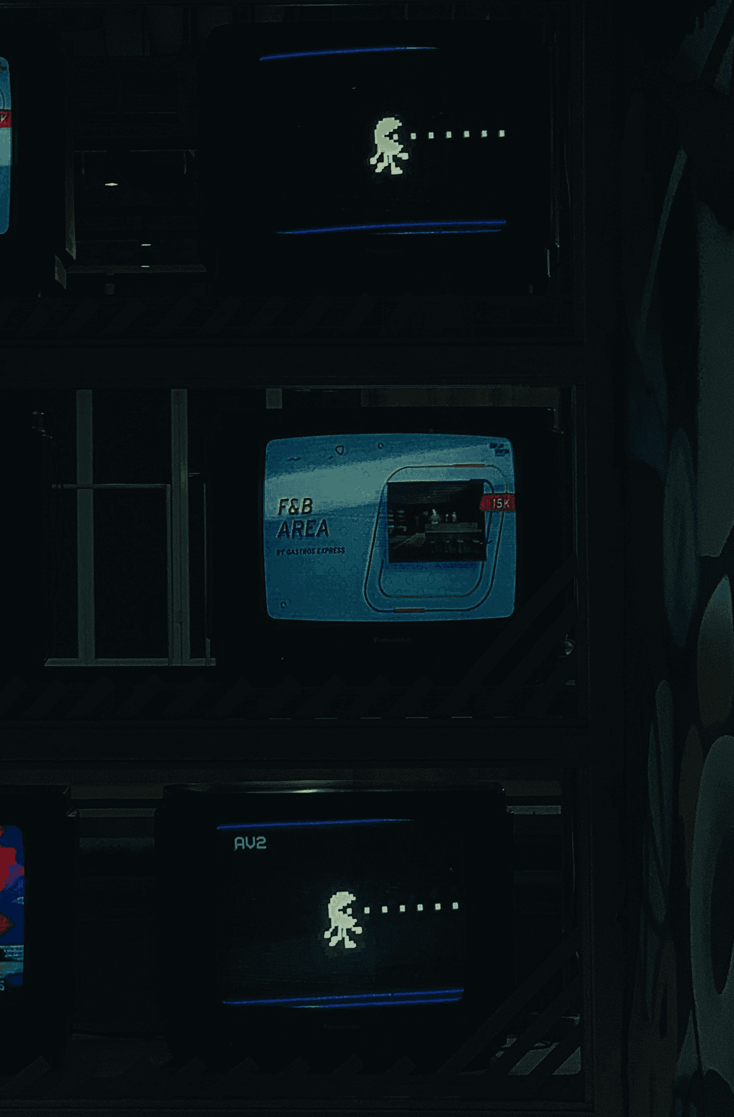 a bunch of tvs that are sitting on a shelf