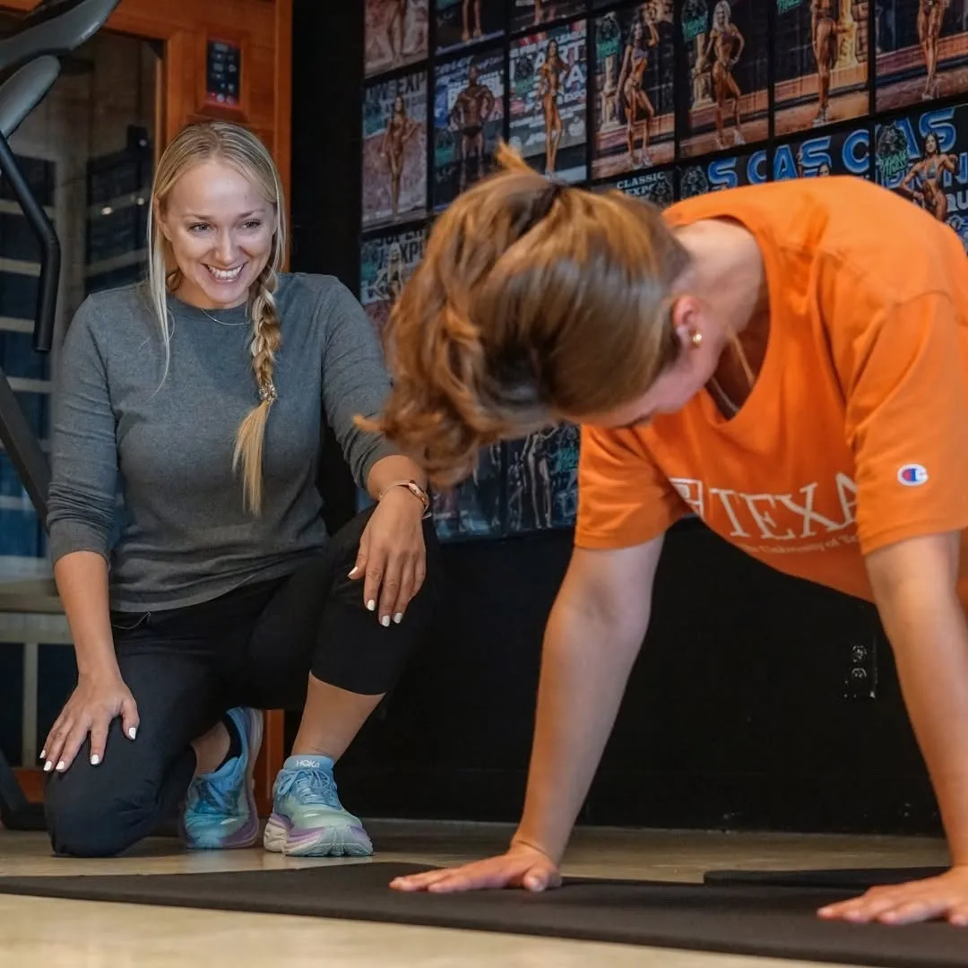 Kathryn Alexander training a client at big tex gym
