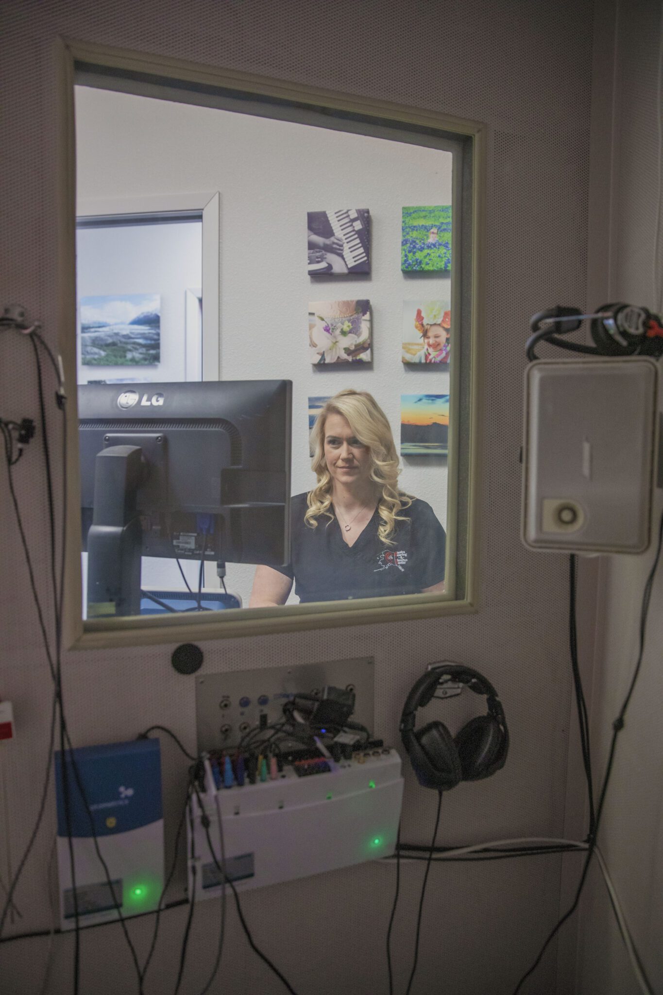A close-up of a person receiving an ear cleaning, with hands gently handling their ear.