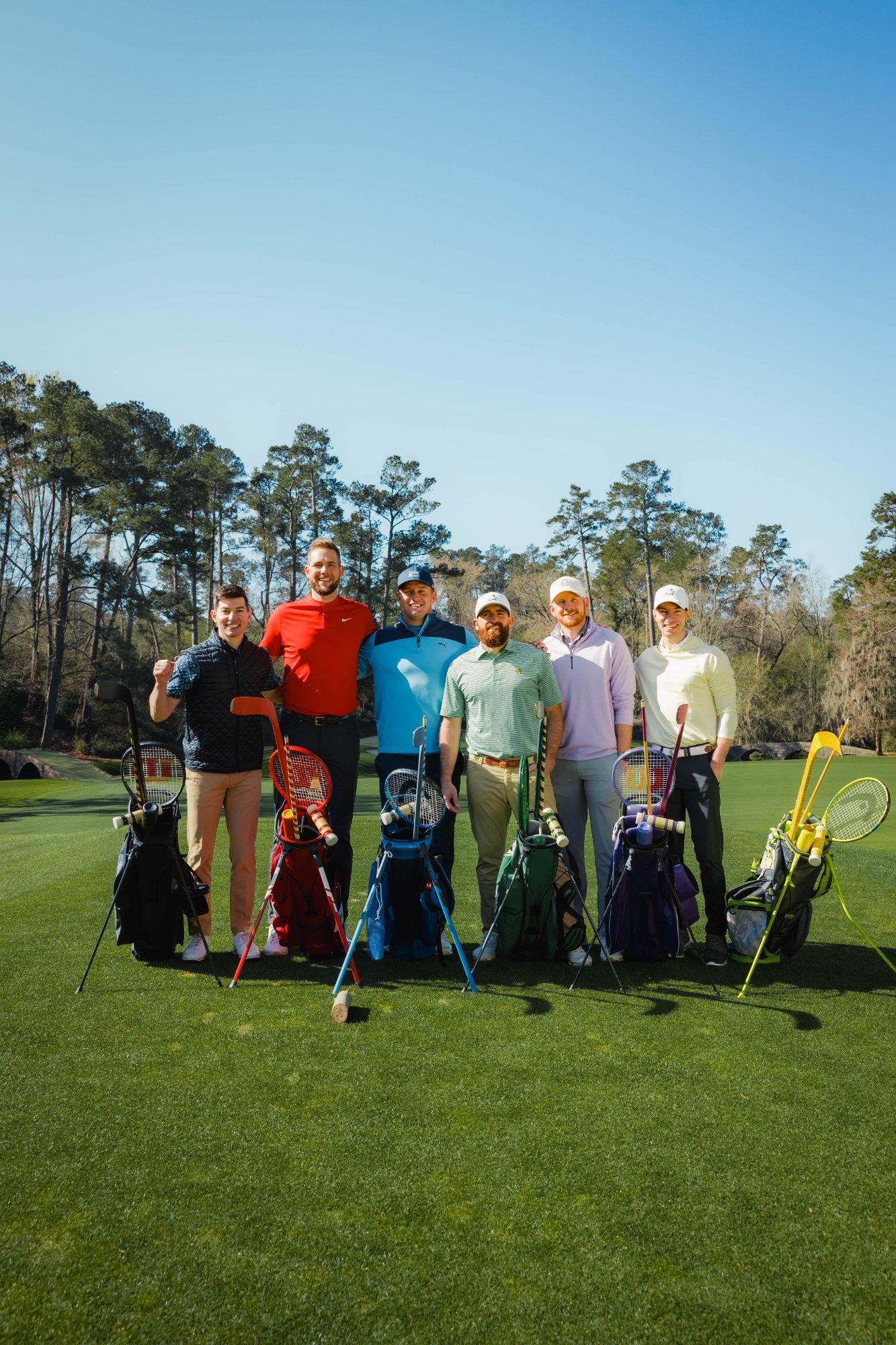A group of men standing with golf gear lined up