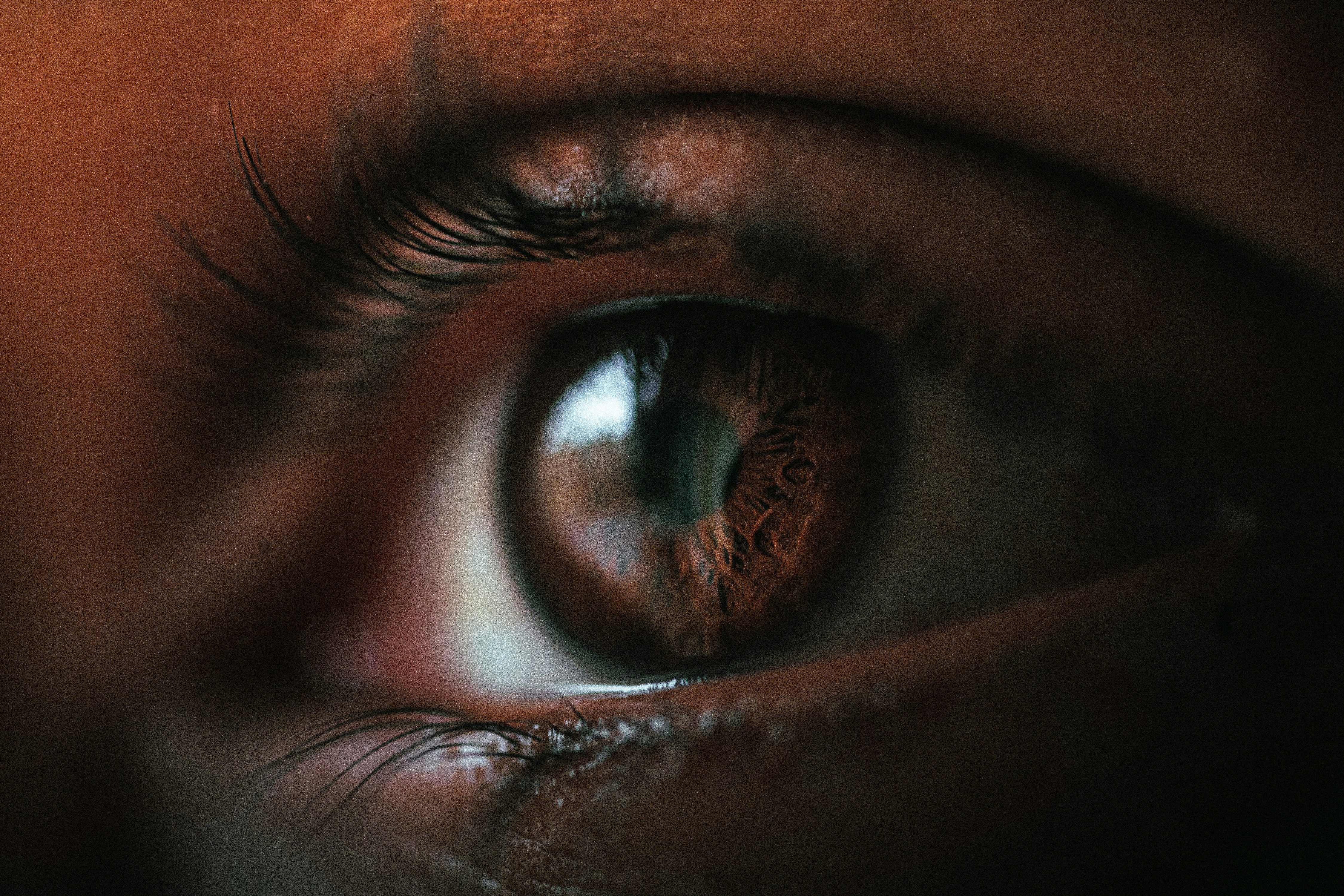 Close-up of a person wearing a delicate gold paperclip chain necklace paired with a white button-down shirt.
