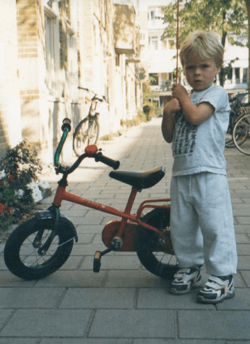 Two gold wedding rings rest atop a soft, textured fabric with a subtle pattern. The rings shine under gentle light, evoking themes of love and commitment.