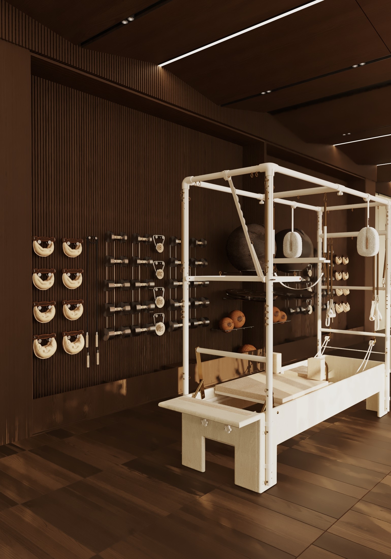 Pilates reformer and equipment in a modern studio with wood floors and dark wood walls.