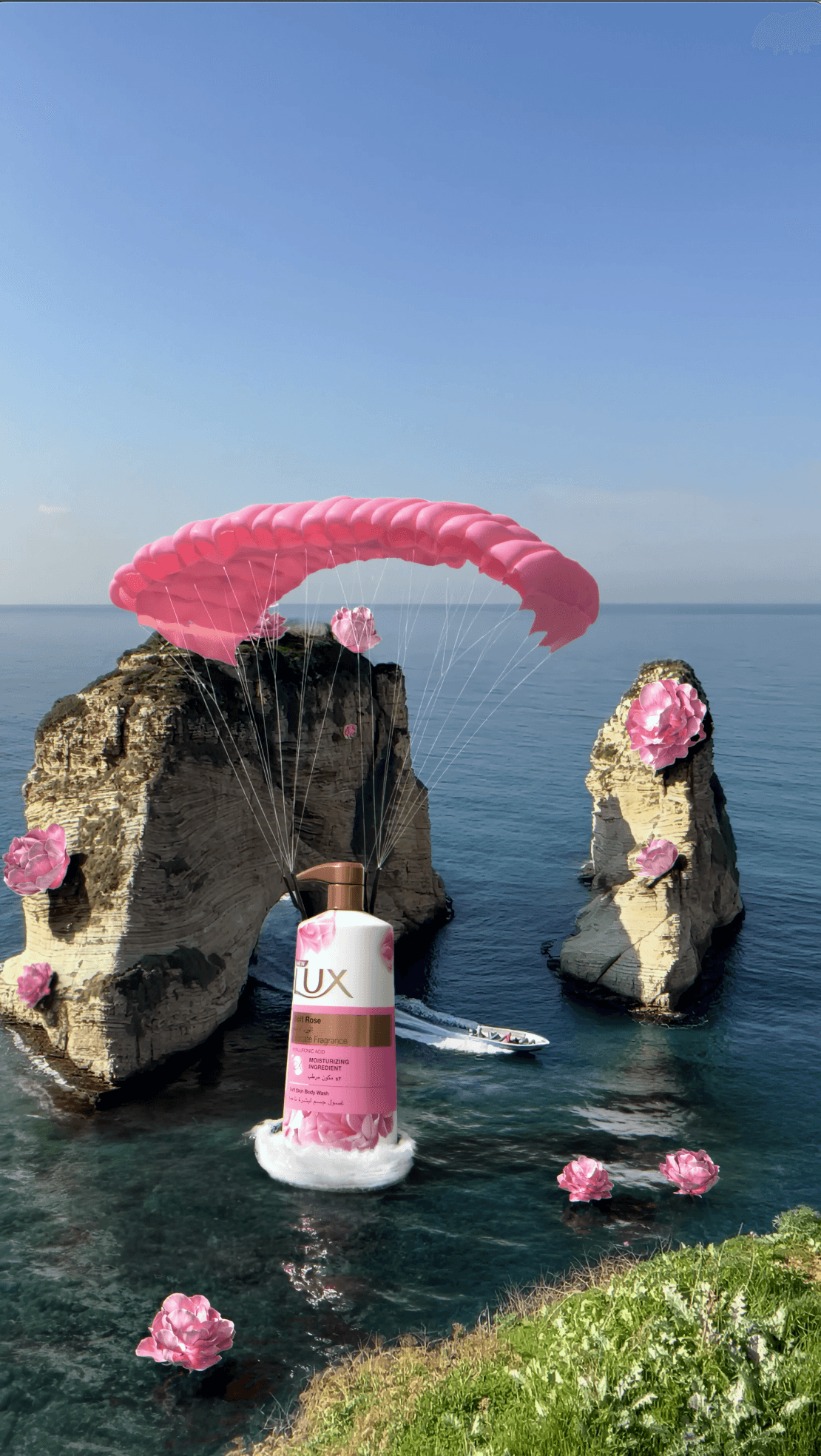 A giant bottle of Lux body wash floating over the ocean with a pink parachute