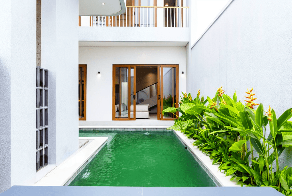 Stylish living room with stone feature wall and sleek staircase in a prime Seseh real estate listing.