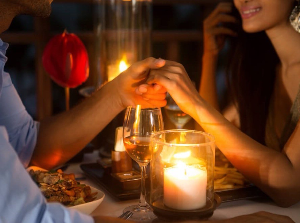 Romantic candlelight dinner at Au Revoir Resort, featuring an intimate setting with warm candlelight, gourmet cuisine, and a breathtaking ambiance.