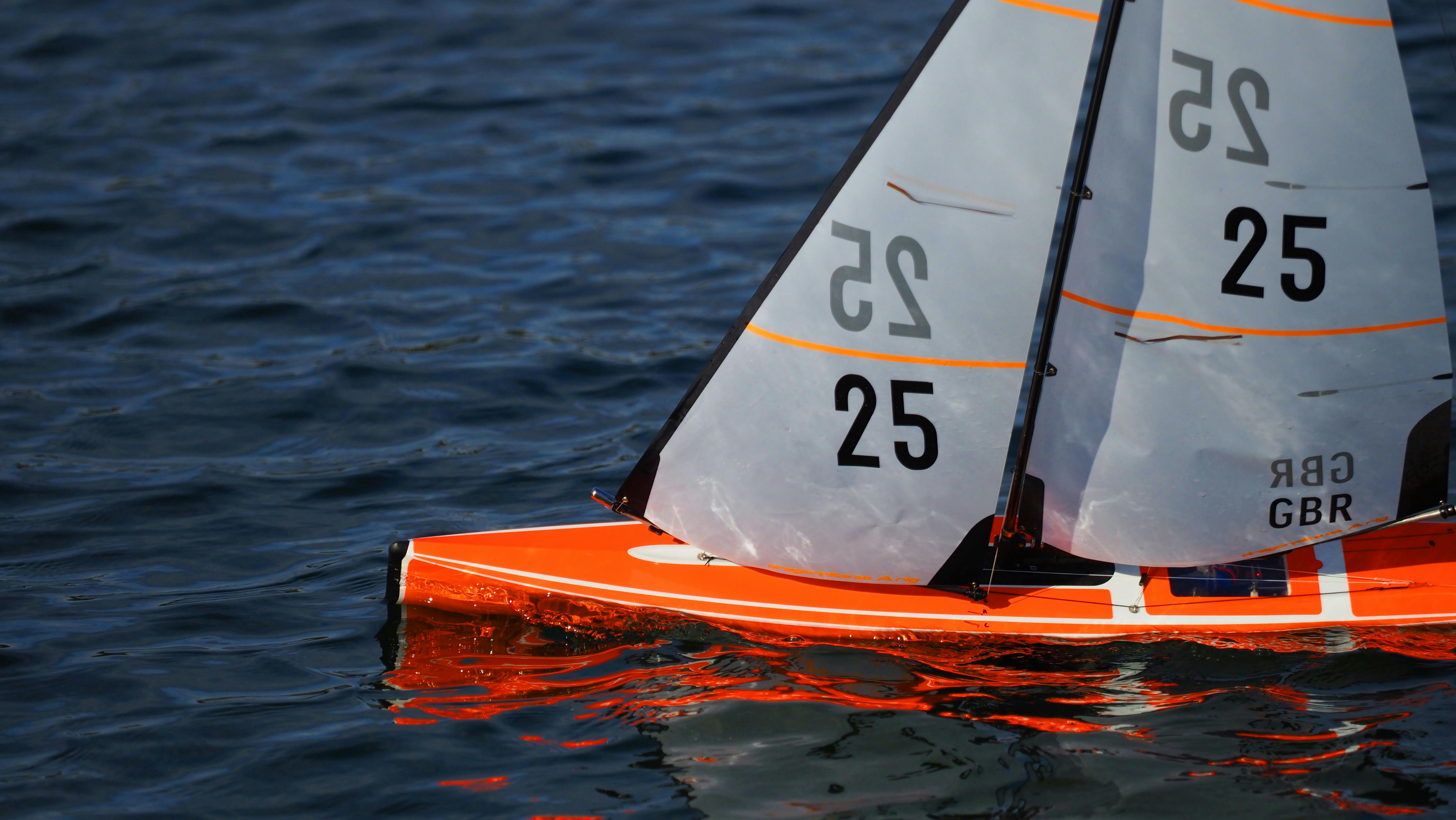 Petit voilier rouge sur une eau calme