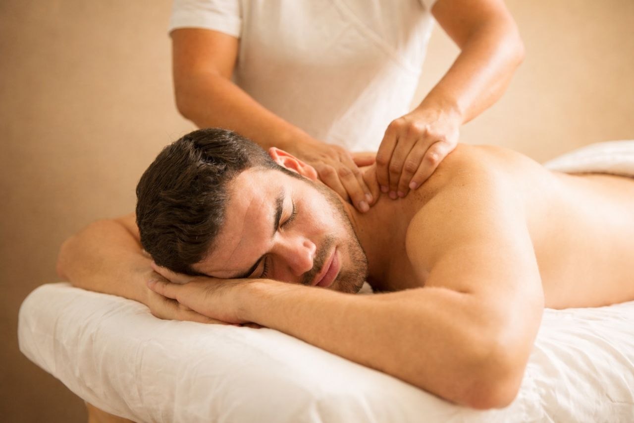 Patient receiving gentle neck and upper-body manual therapy