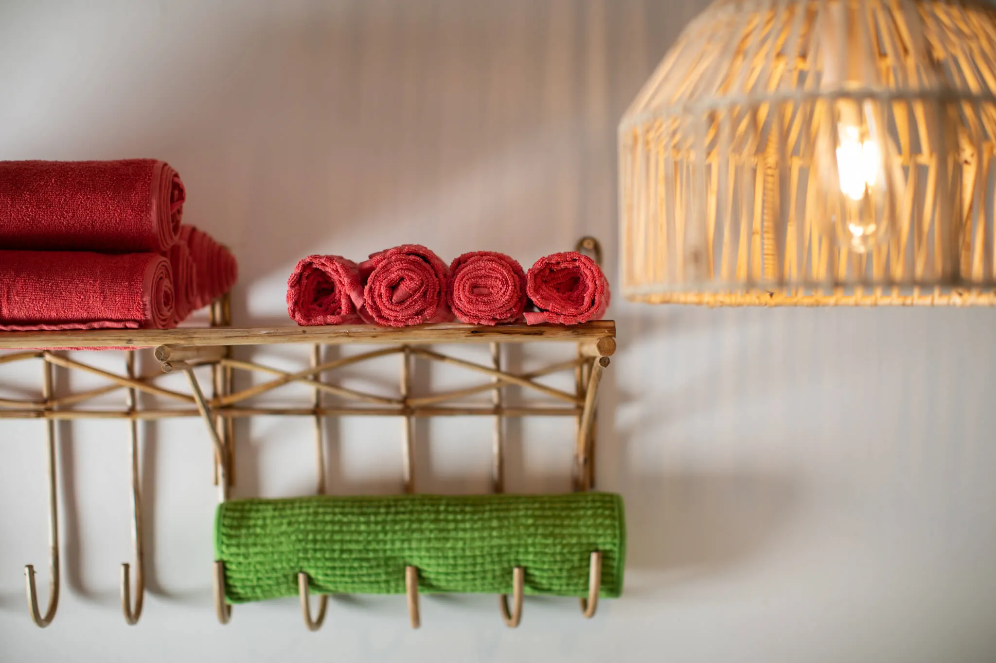 Hand-rolled towels on a cane rack at Casa Jaali