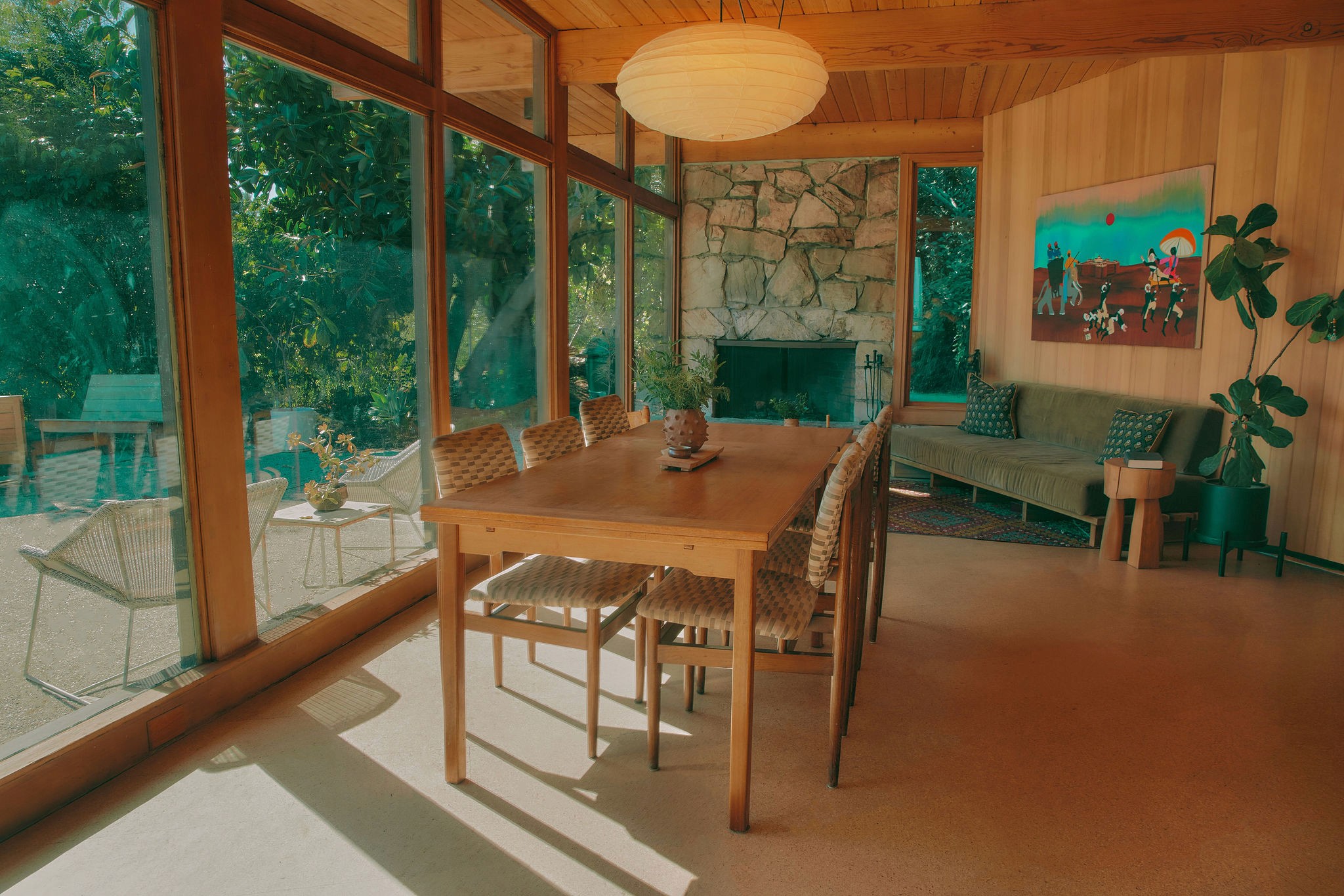 Young woman with dark hair and bangs, wearing red.