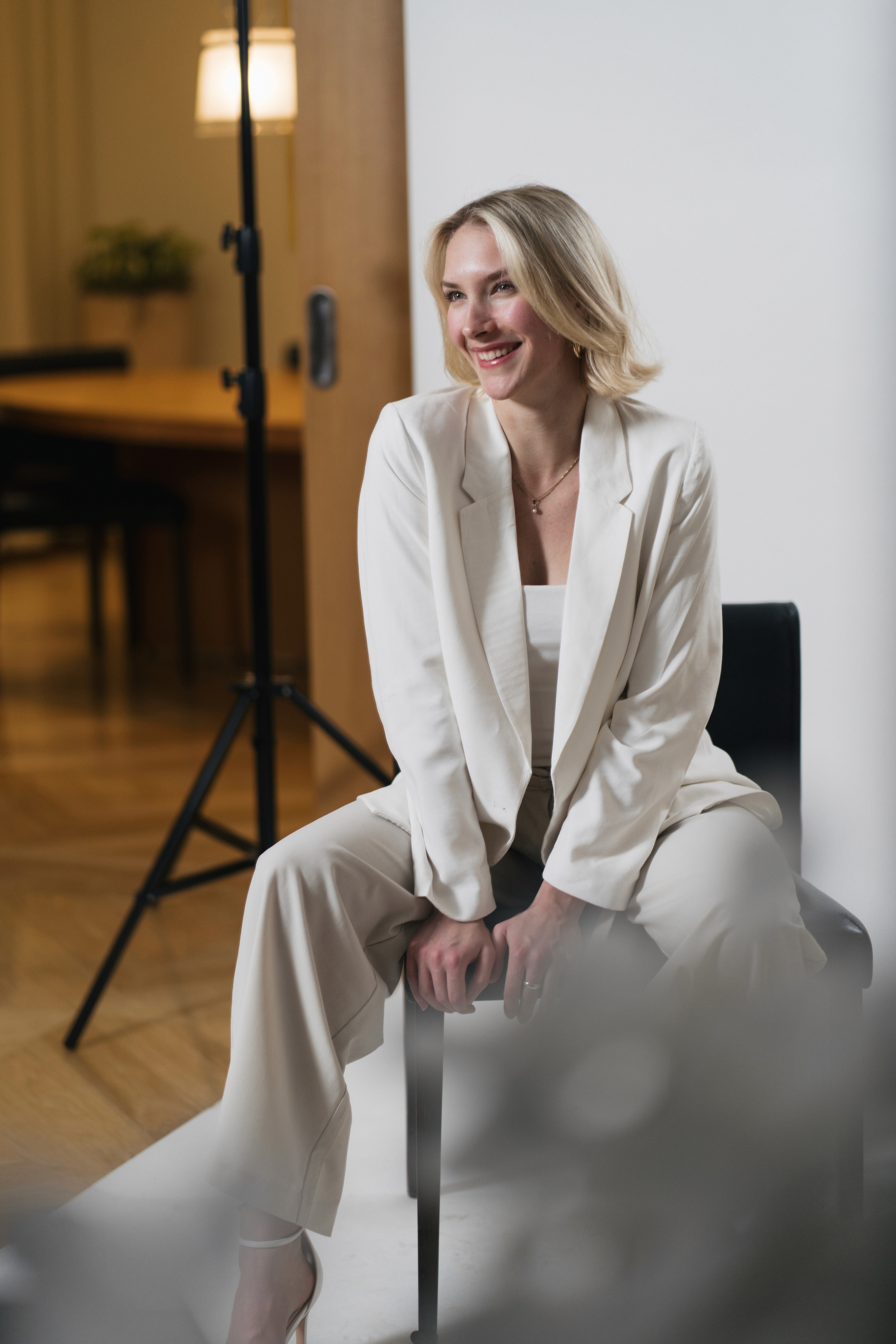 Business Women sitting on a chair and is smiling