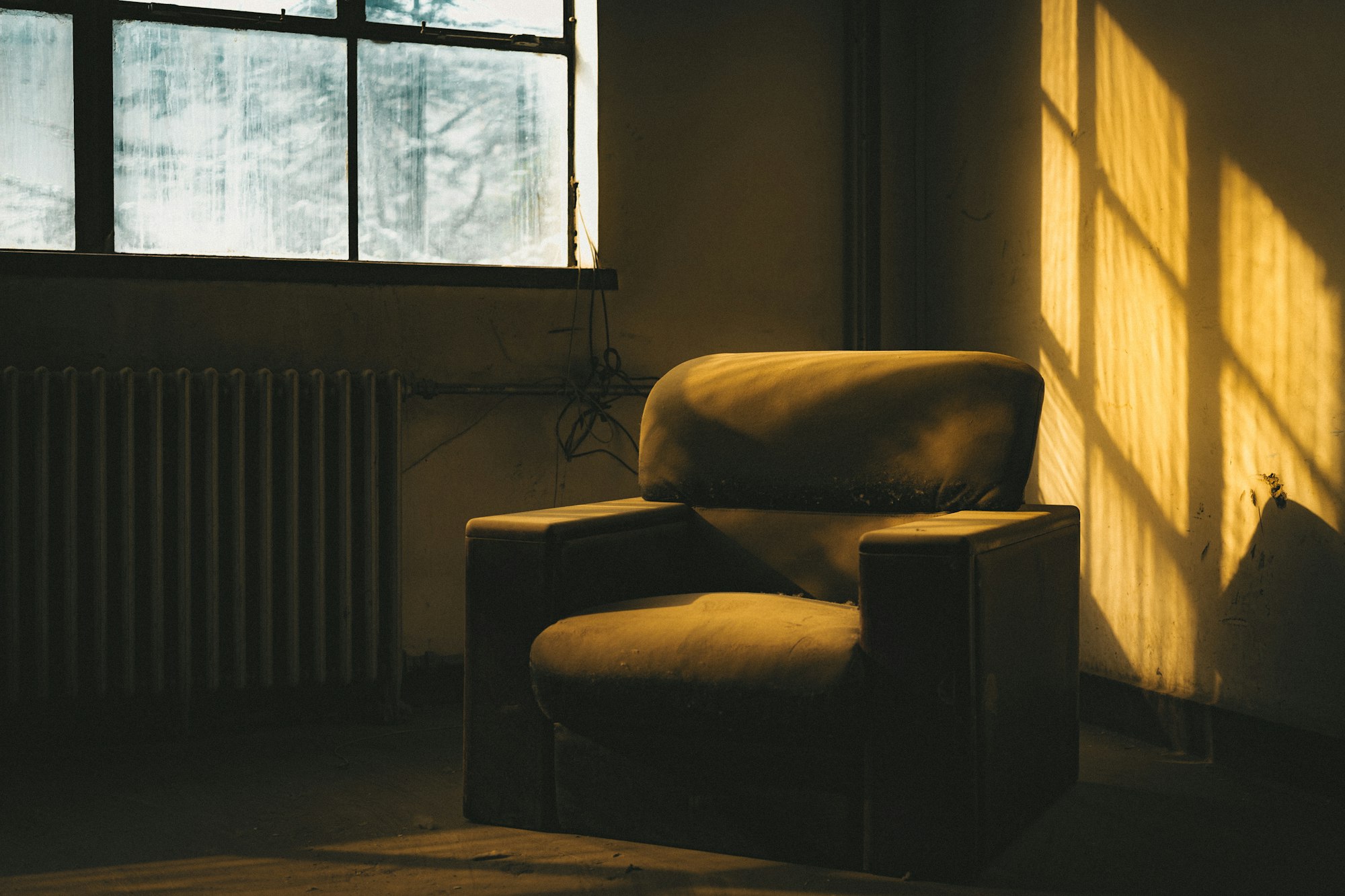 An empty armchair in late afternoon light