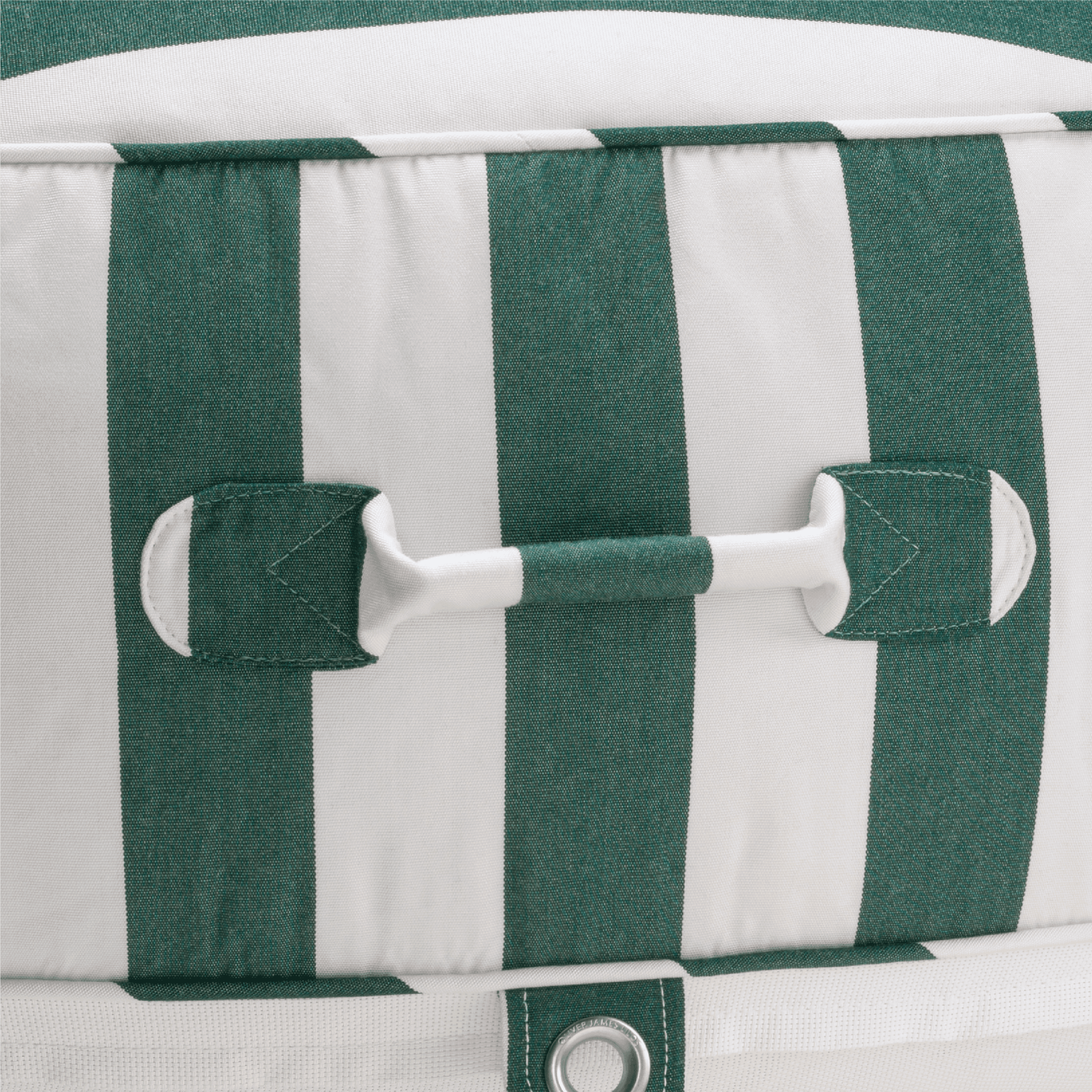 Close-up of a pool float with green-and-white canvas handle, topstitched seams, and stainless eyelet