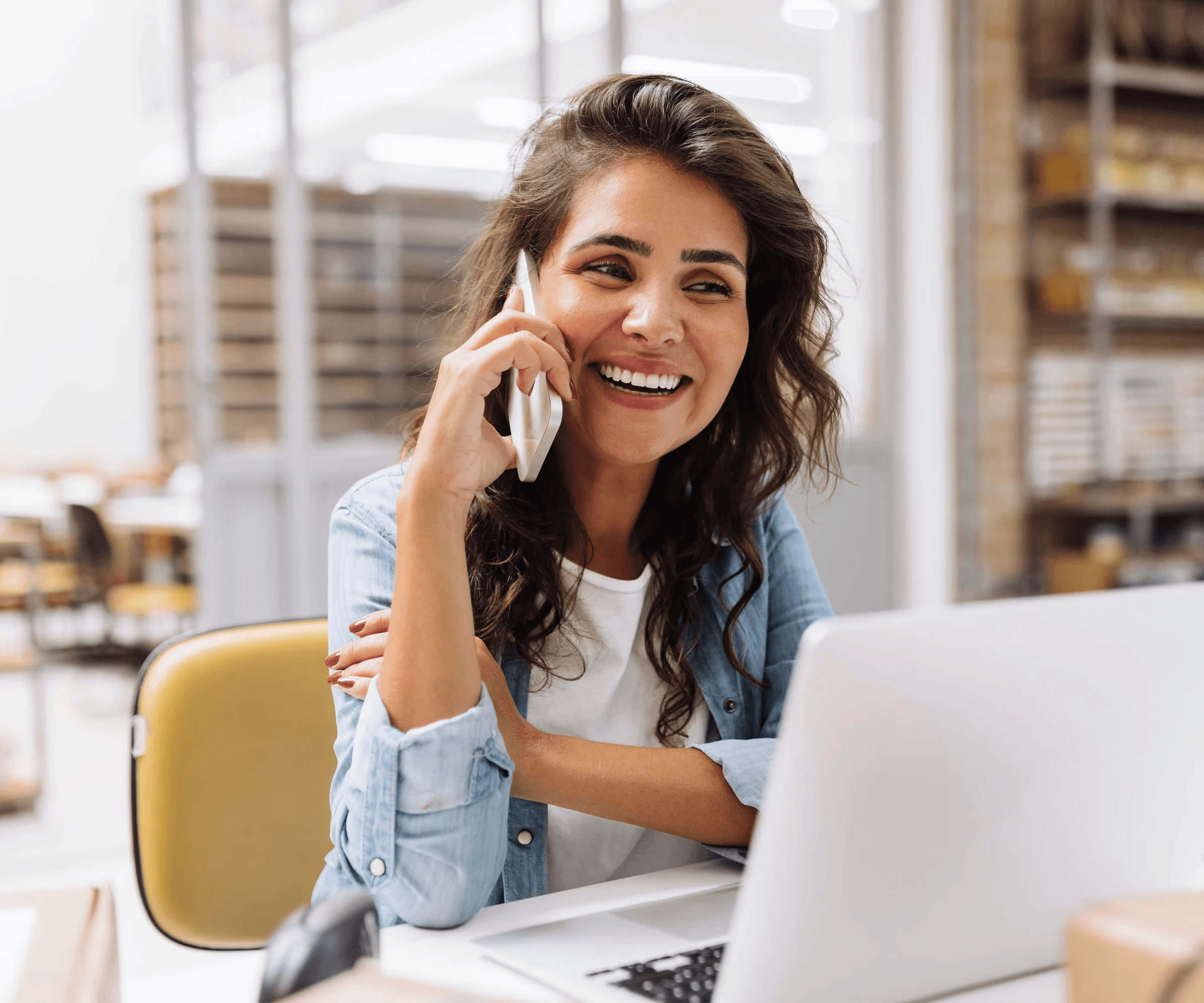 A smiling business owner talking on the phone